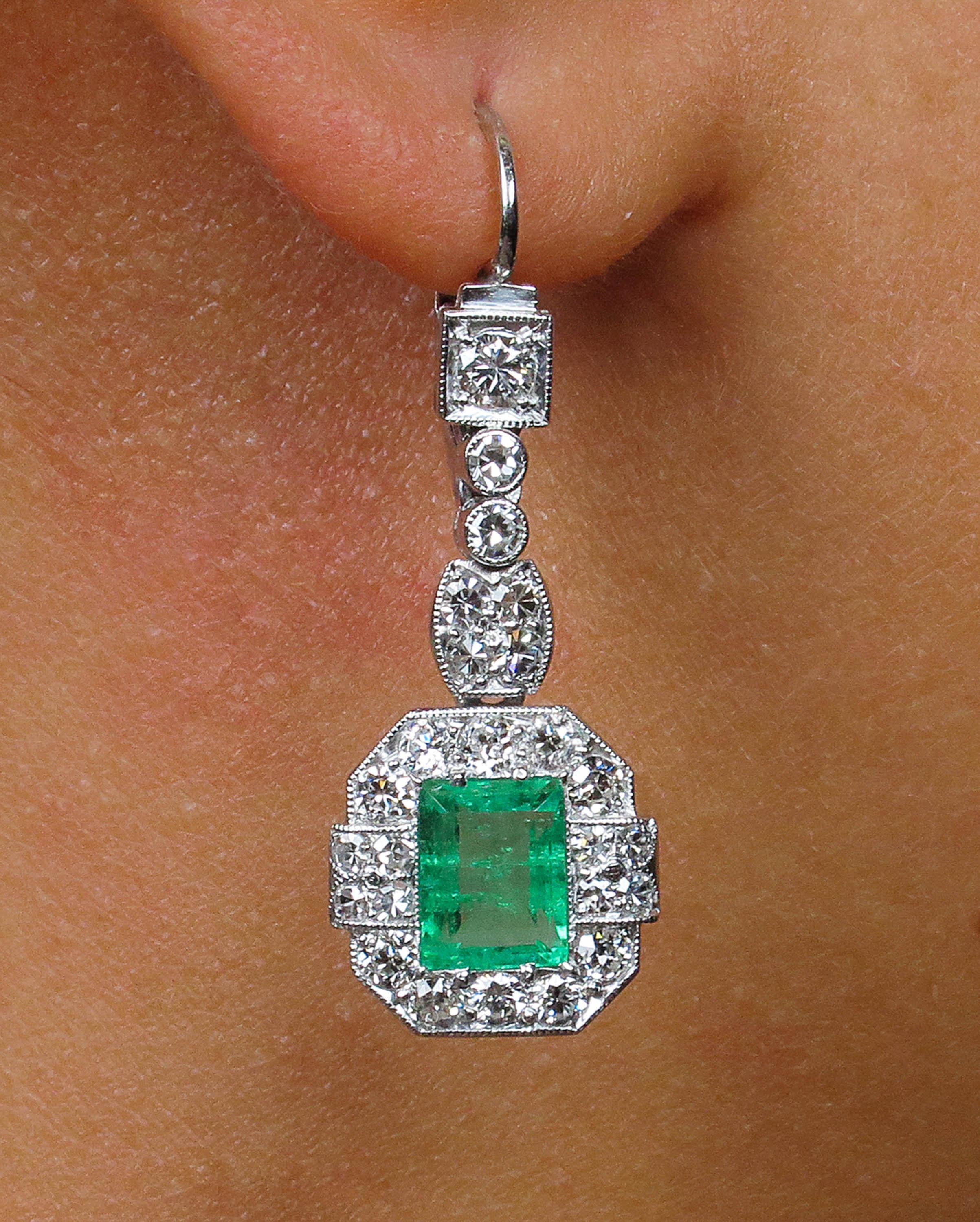 A wonderful Authentic Late Edwardian/ Early Art Deco CIRCA 1915s GIA Certified Green Emerald Diamond Drop Earrings in Platinum (tested).
The each Center Stone is Natural Colombian Green Step cut Emerald, estimated total weight is 2.46ct. NO