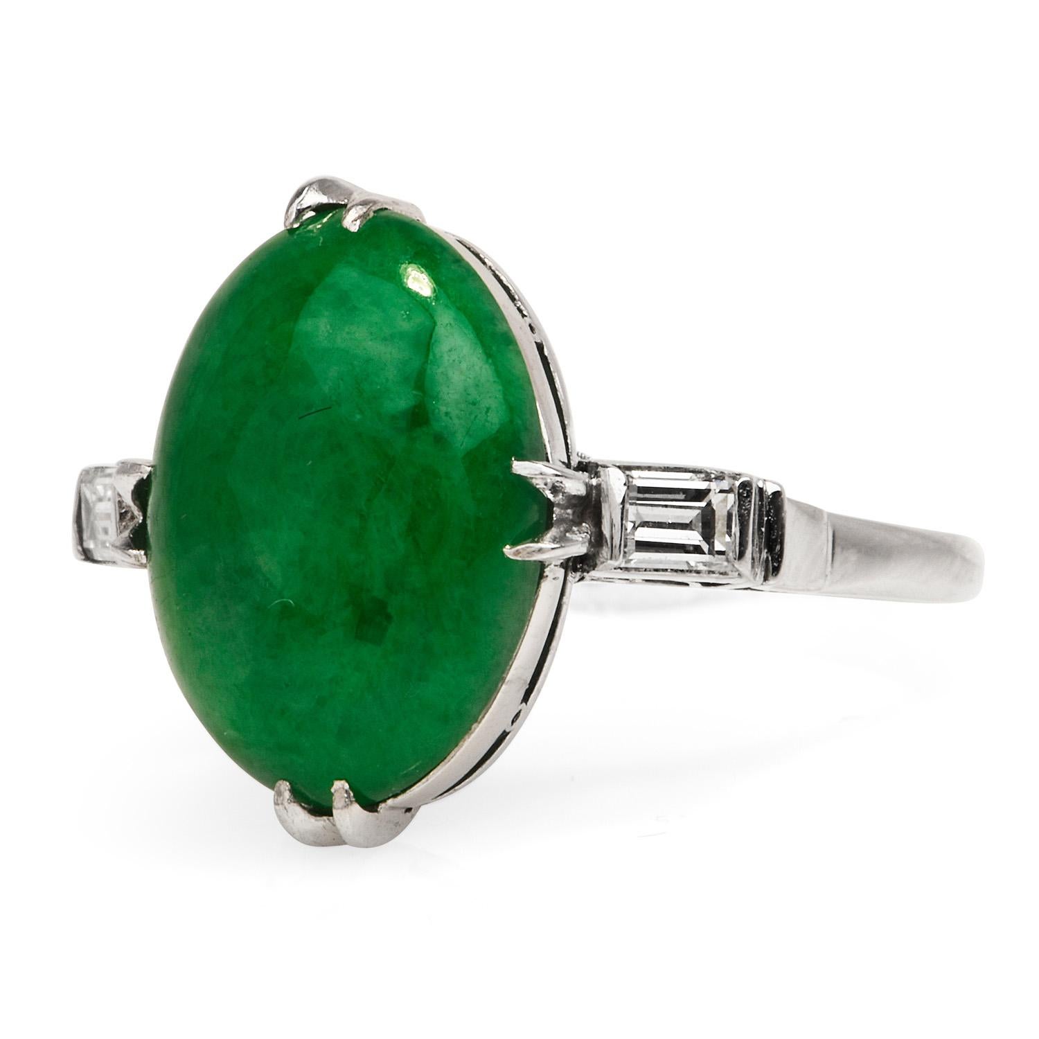 Green Natural Jadeite Jade ring enhanced by two baguette diamonds, 

Crafted in solid Platinum, the center is adorned by a GIA certified Green Jade, untreated, cabochon oval cut,

prong-set, weighing approximately 4.82 carats. 

Complimenting the