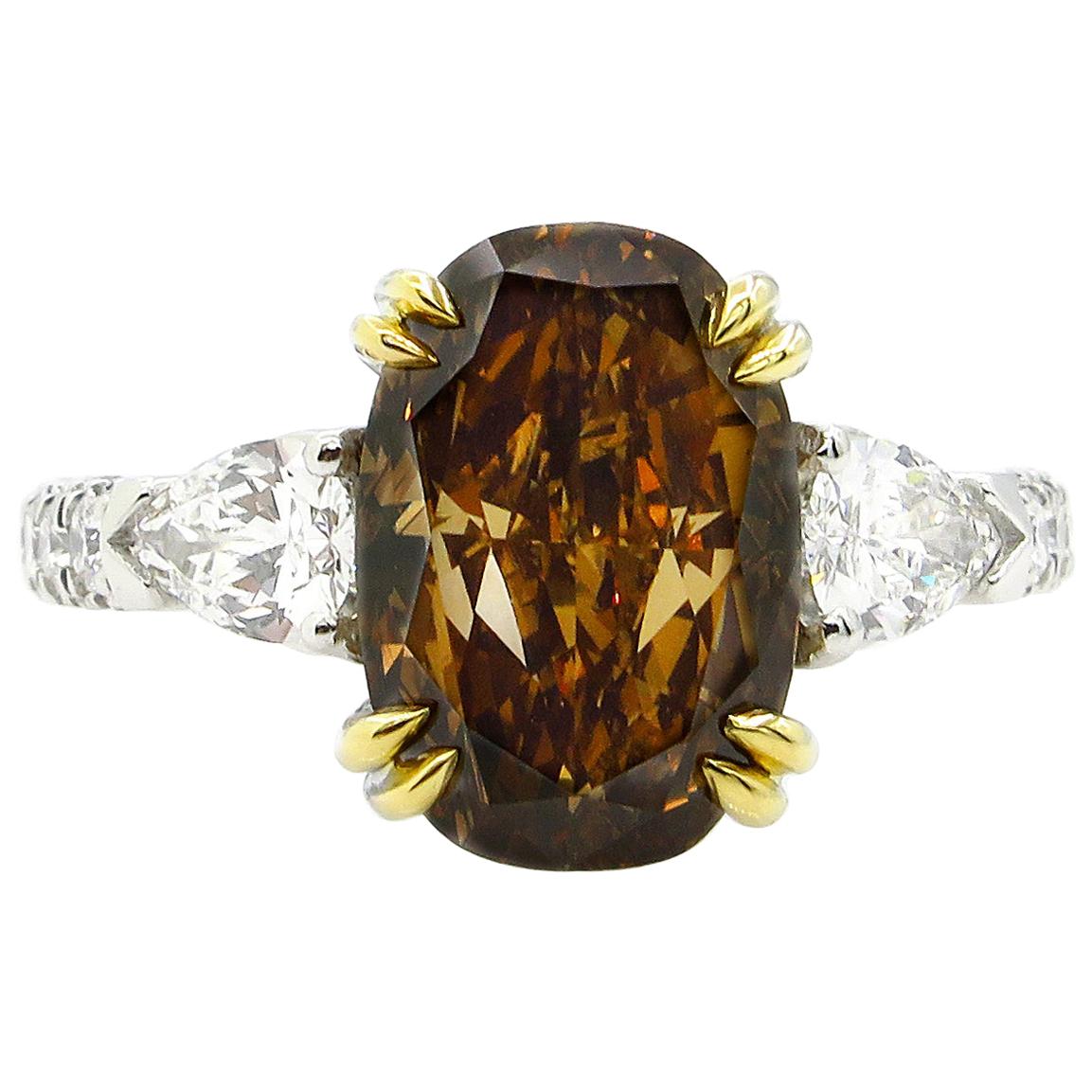 GIA 4.85 Carat Natural Fancy Brown Orange Oval Cut Diamond 3-Stone Platinum Ring