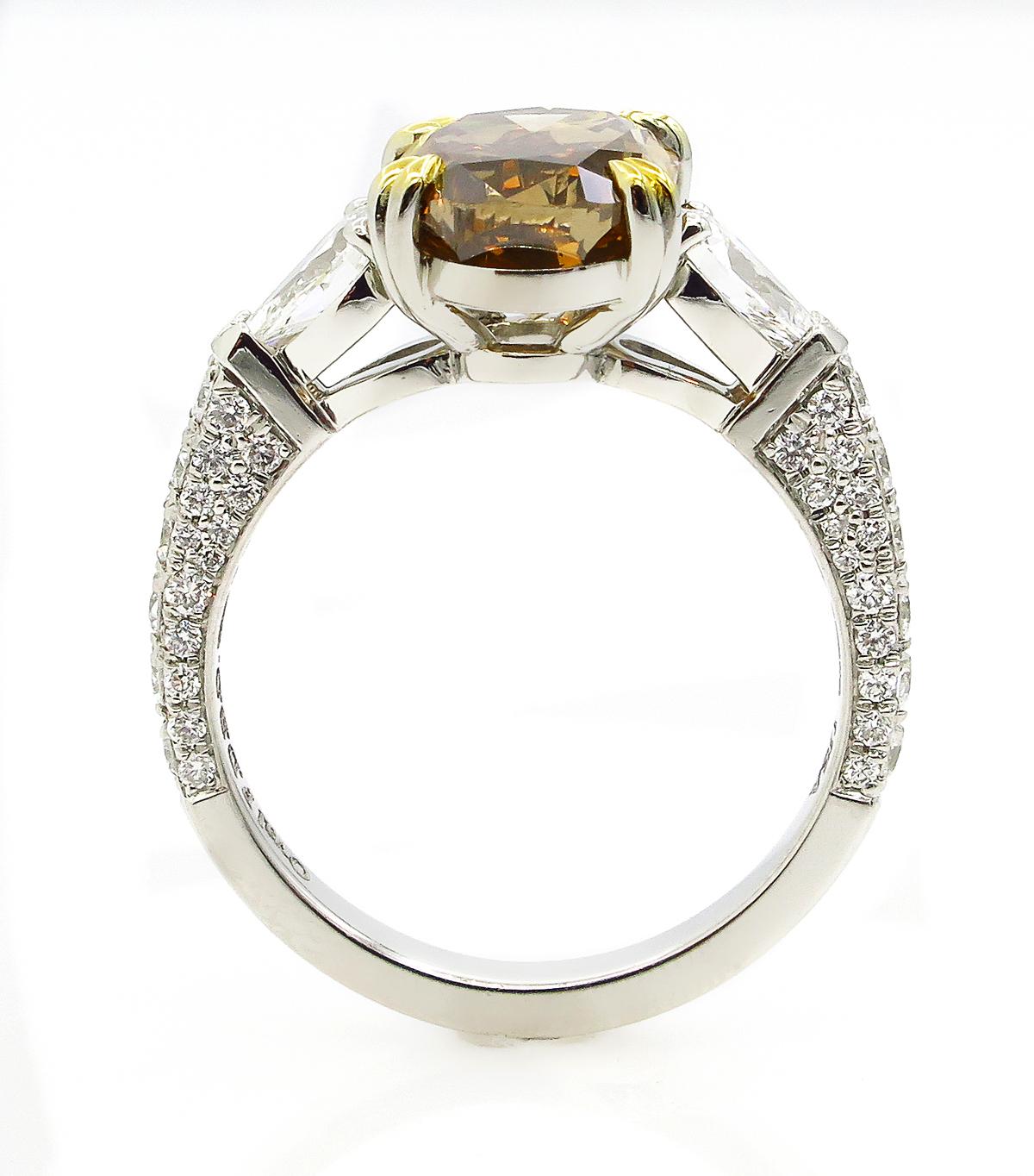 GIA 4.85 Carat Natural Fancy Brown Orange Oval Cut Diamond 3-Stone Platinum Ring In Good Condition In New York, NY