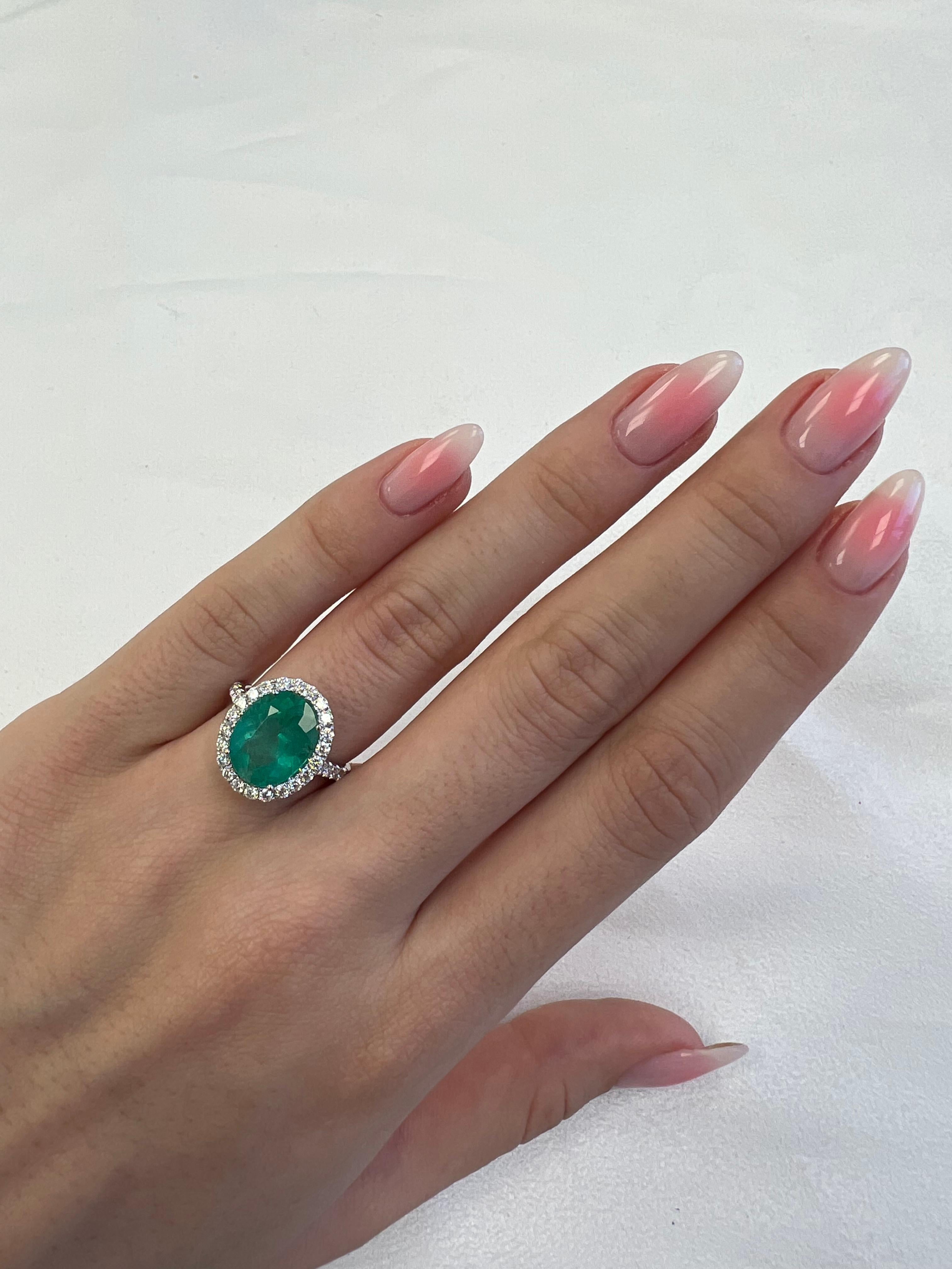 Classic emerald and diamond halo ring, GIA certified. 
4.99 carats total gemstone weight.
4.17 carat oval shape emerald, F1, GIA certified. Complimented by 34 round brilliant diamonds, 0.82 carats, F/G color and VS clarity. 18k white gold, 5.12