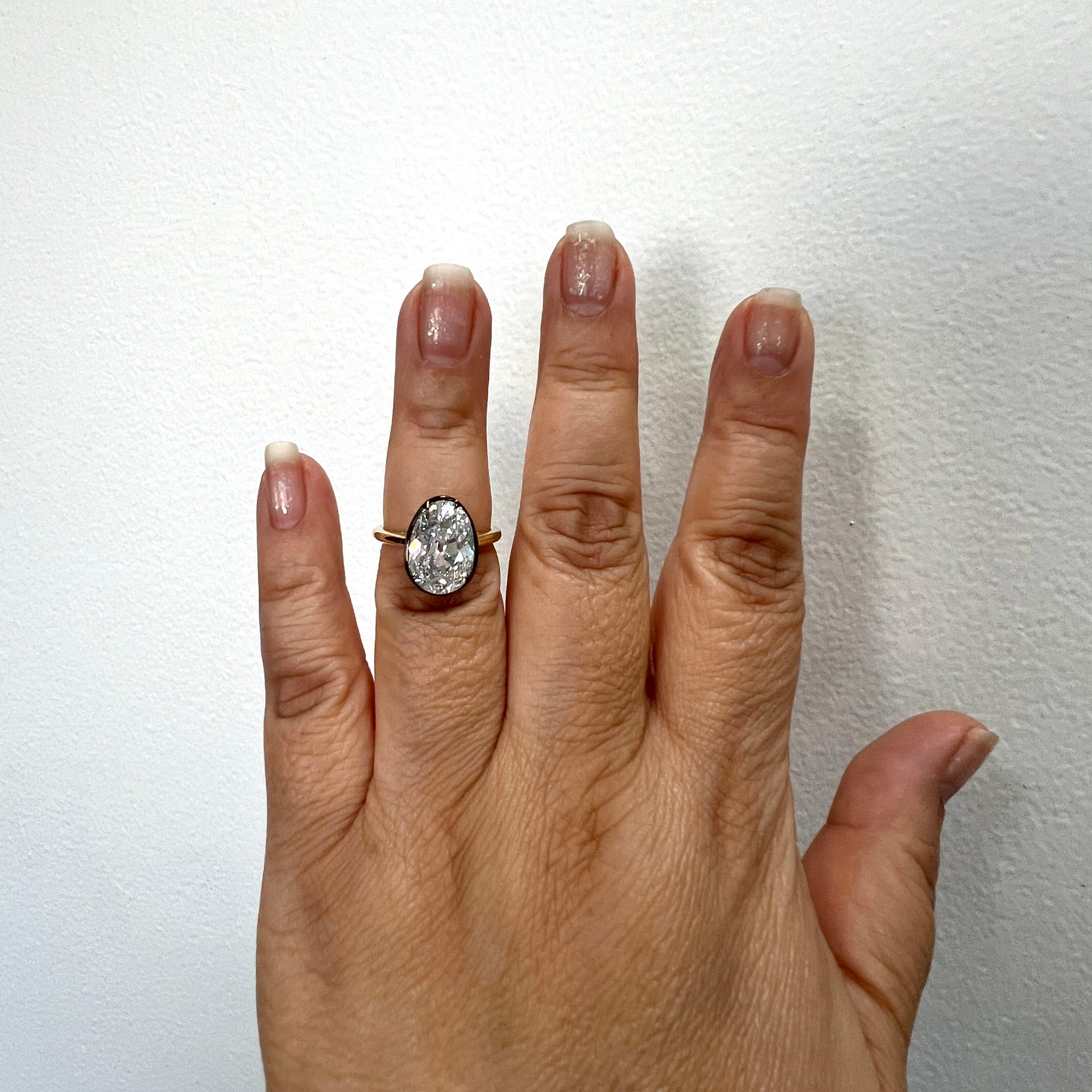 Gorgeous 5.23 ct. F SI2 white diamond oval.  Handmade in 18k yellow gold and black rhodium.  Ring size 6.5.  GIA certificate included.