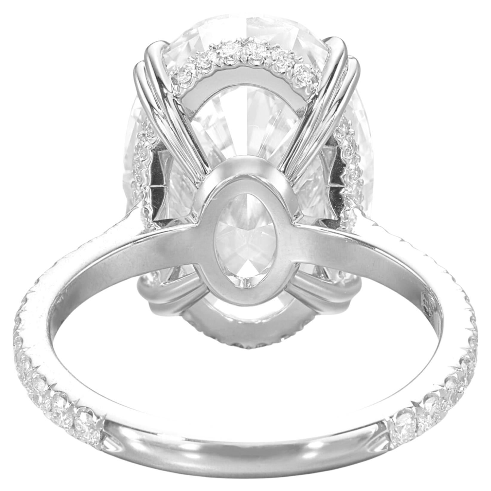 Experience timeless elegance with this breathtaking GIA-certified ring, featuring a magnificent 5-carat oval-cut diamond. Graded E color and VVS2 clarity, this diamond boasts exceptional brilliance and near-flawless clarity, further enhanced by its