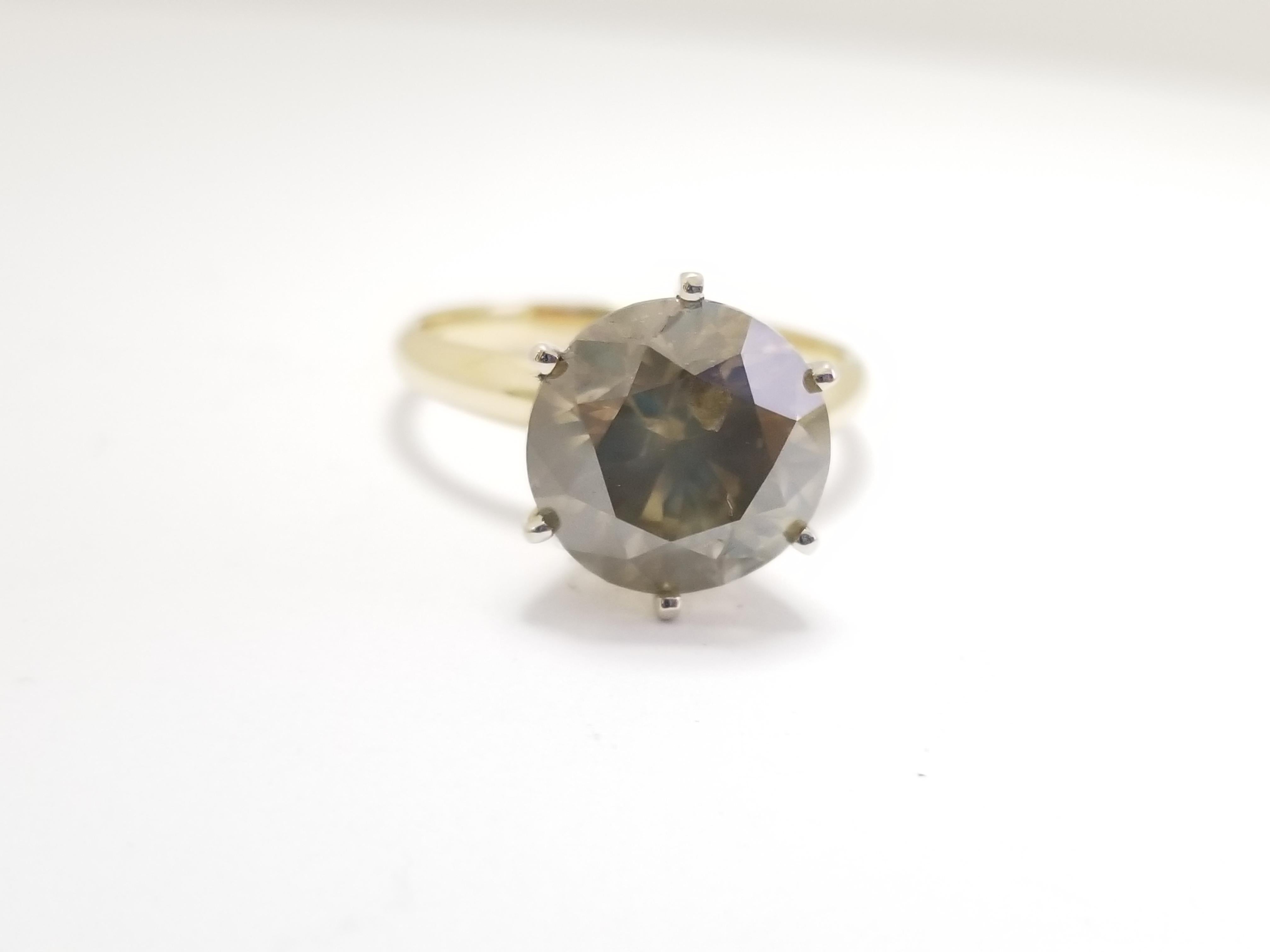 Natural Fancy Brown-Greenish Yellow Round Diamond Ring weighing 5.01 carats. Set on 6-prong 14K solitaire yellow gold. Ring size: 7