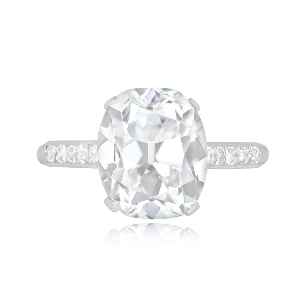 This exquisite engagement ring boasts a GIA-certified elongated cushion-cut diamond, 5.01 carats in weight, with D color and VS1 clarity. The central diamond is elegantly secured in prongs, flanked by five French cut diamonds on each shoulder,