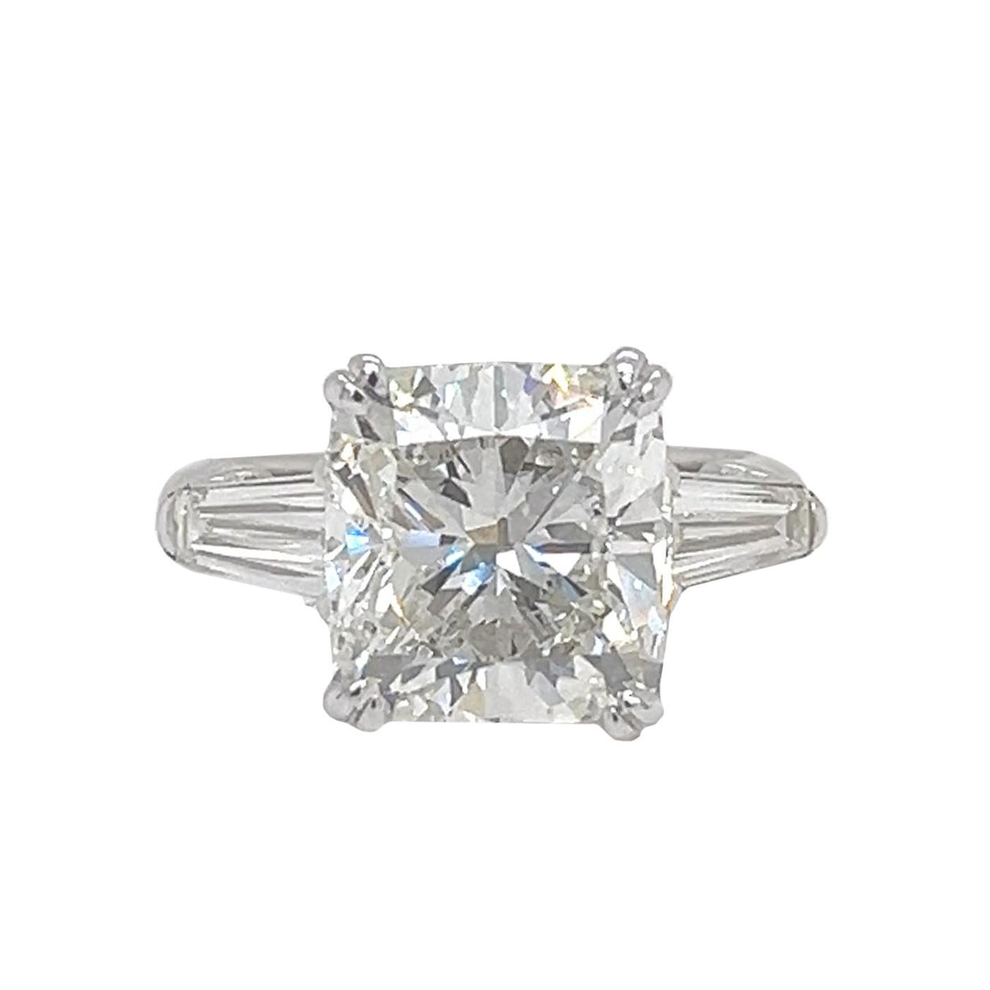 Presenting an exquisite GIA-certified 5.02-carat natural cushion-cut diamond engagement ring, Meticulously crafted to showcase unparalleled elegance. The center diamond has brilliance with exceptional Si1 clarity and J color, embodying the timeless