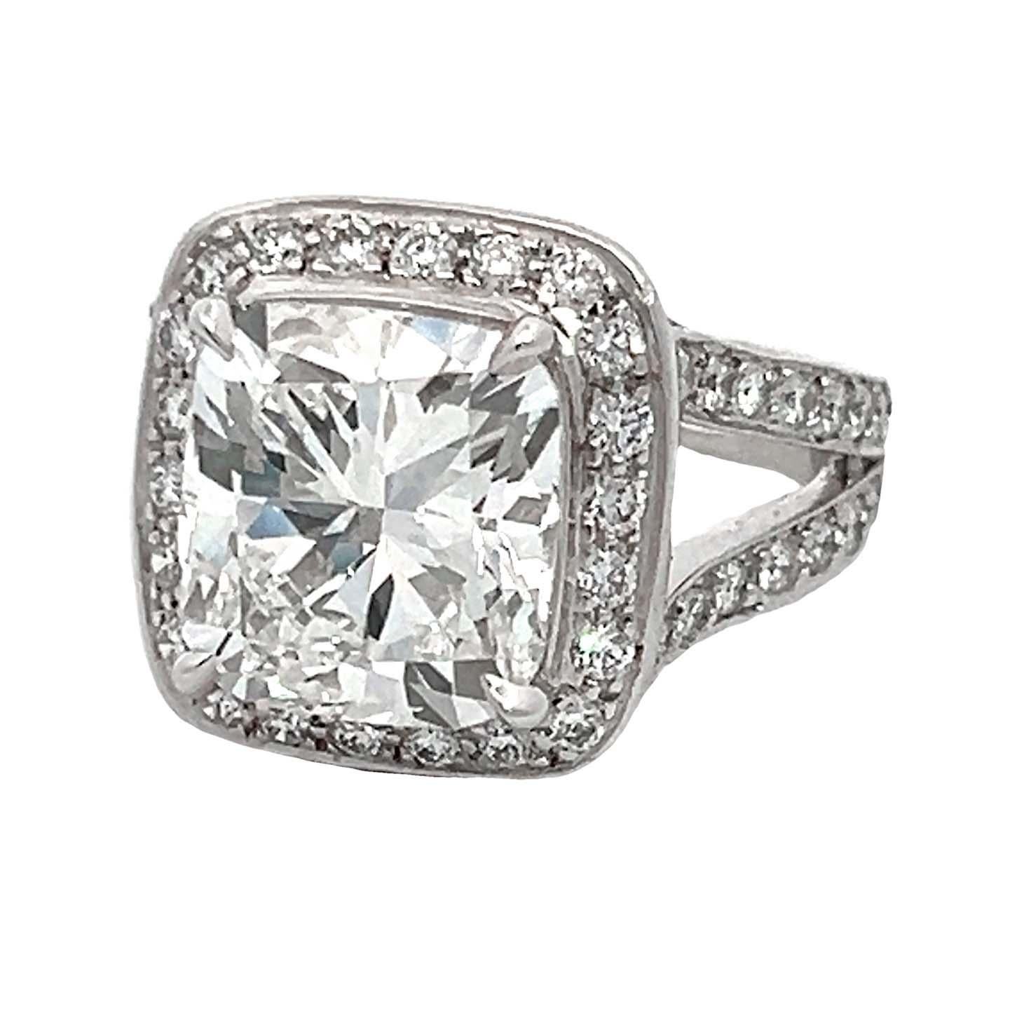 GIA-certified Platinum Bezel Set Halo Style Diamond Engagement Ring, featuring a stunning 5.05-carat cushion modified brilliant center stone. This GIA-certified gem boasts an exceptional H color and VS1 clarity, reflecting light with unparalleled