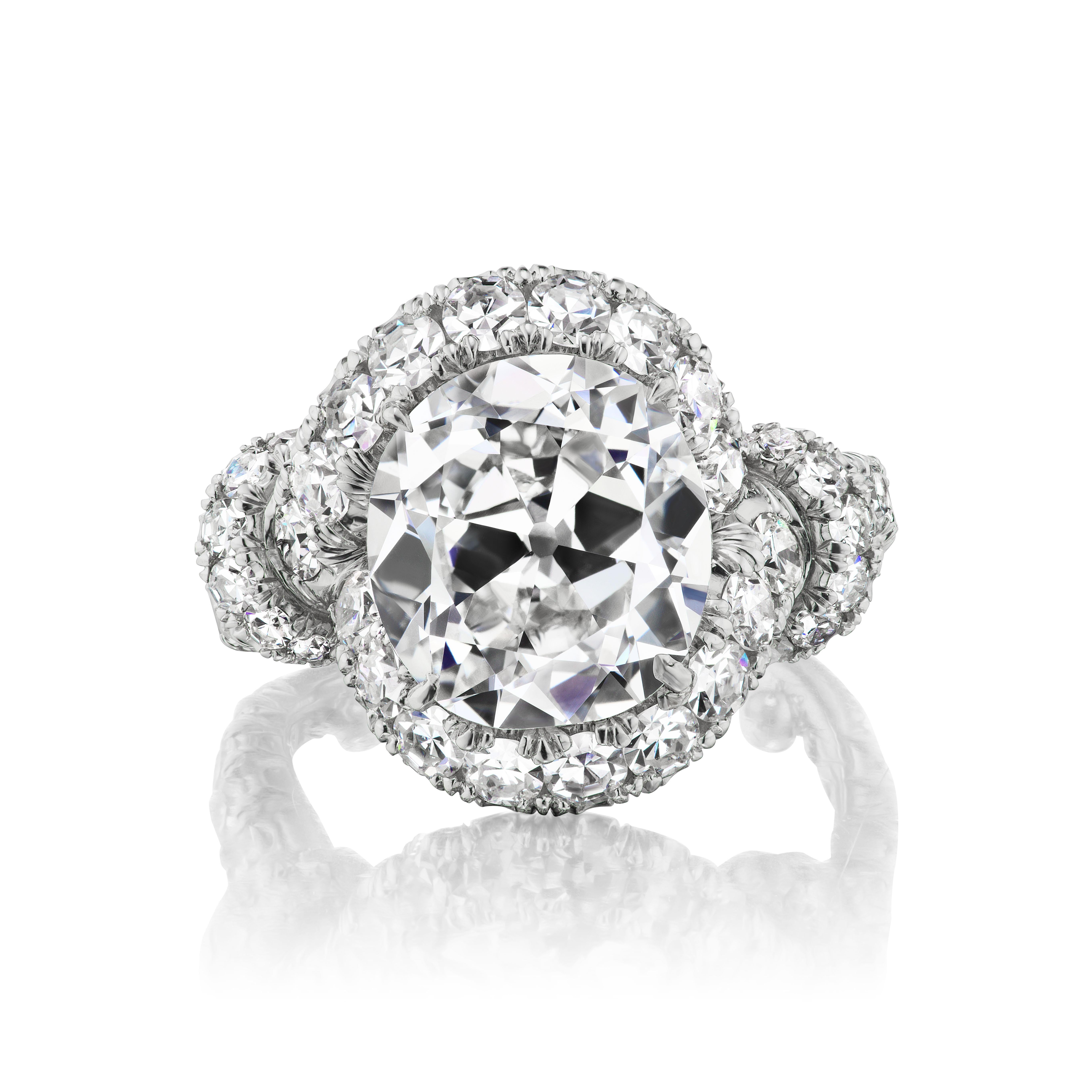The rare and charming 5.06 carat antique cushion-cut diamond is elegantly presented in a delightful diamond and platinum ring made up of 48 single-cut diamonds weighing approximately 1.94 carats. This ring is defined by its knot feature at the