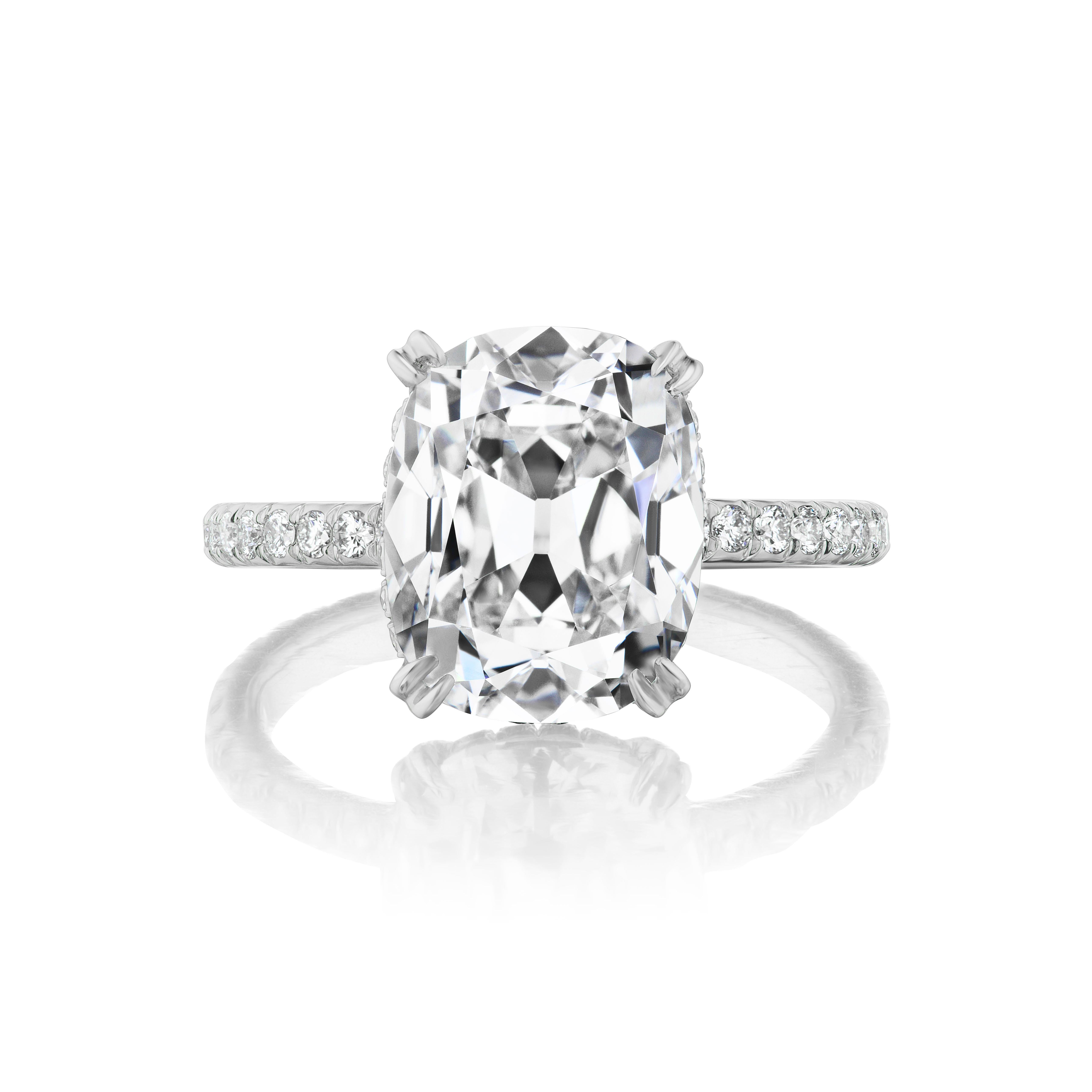 This rare and charming 5.07 carat antique cushion-cut diamond is mounted in a simple and delightful diamond pavé and platinum ring with diamonds weighing approximately 1.50 carats on the basket, seat, and full length of the band. 

Comes with GIA