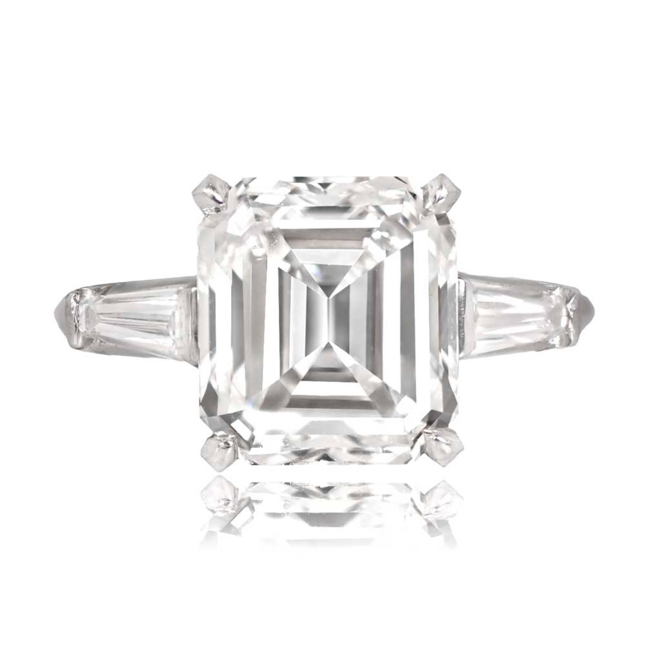 A platinum engagement ring with a GIA-certified 5.09-carat emerald-cut diamond at G color and VS1 clarity, set in prongs. It also features tapered baguette-cut diamonds on the shoulders. A copy of the GIA certificate can be provided upon