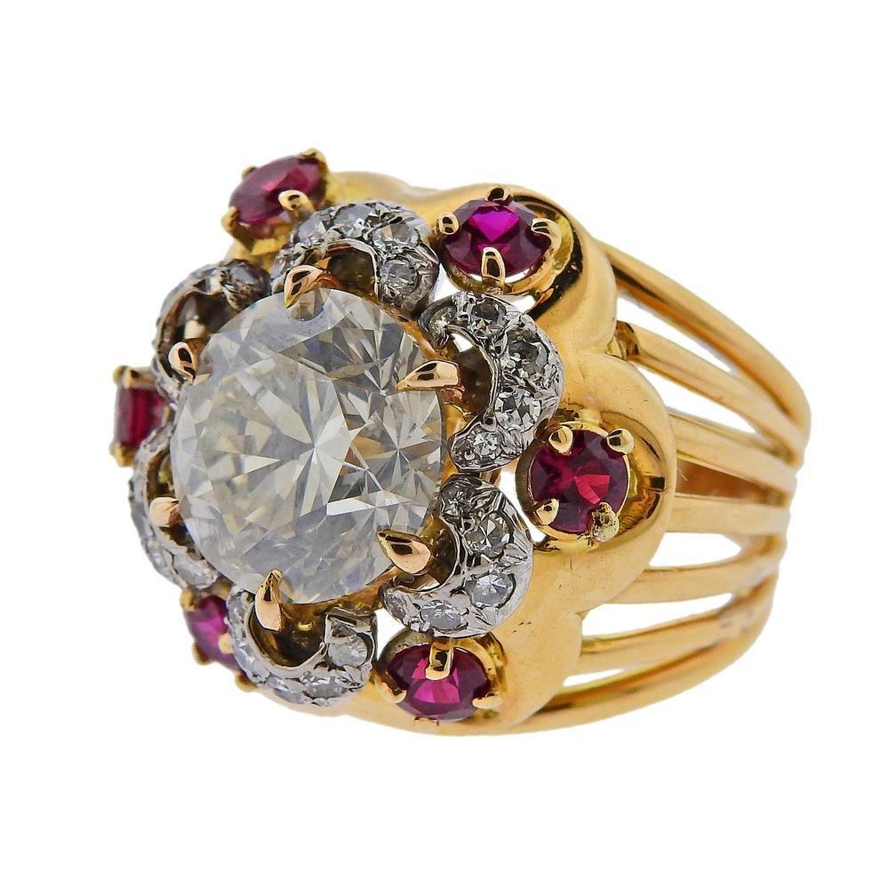 14k gold ring, set with one 5.10ct round brilliant diamond, GIA certified, K color, I1 clarity. Surrounded with rubies and diamonds. Ring size - 6, ring top - 20mm wide. Tested 14k. Weight 12.1 grams.