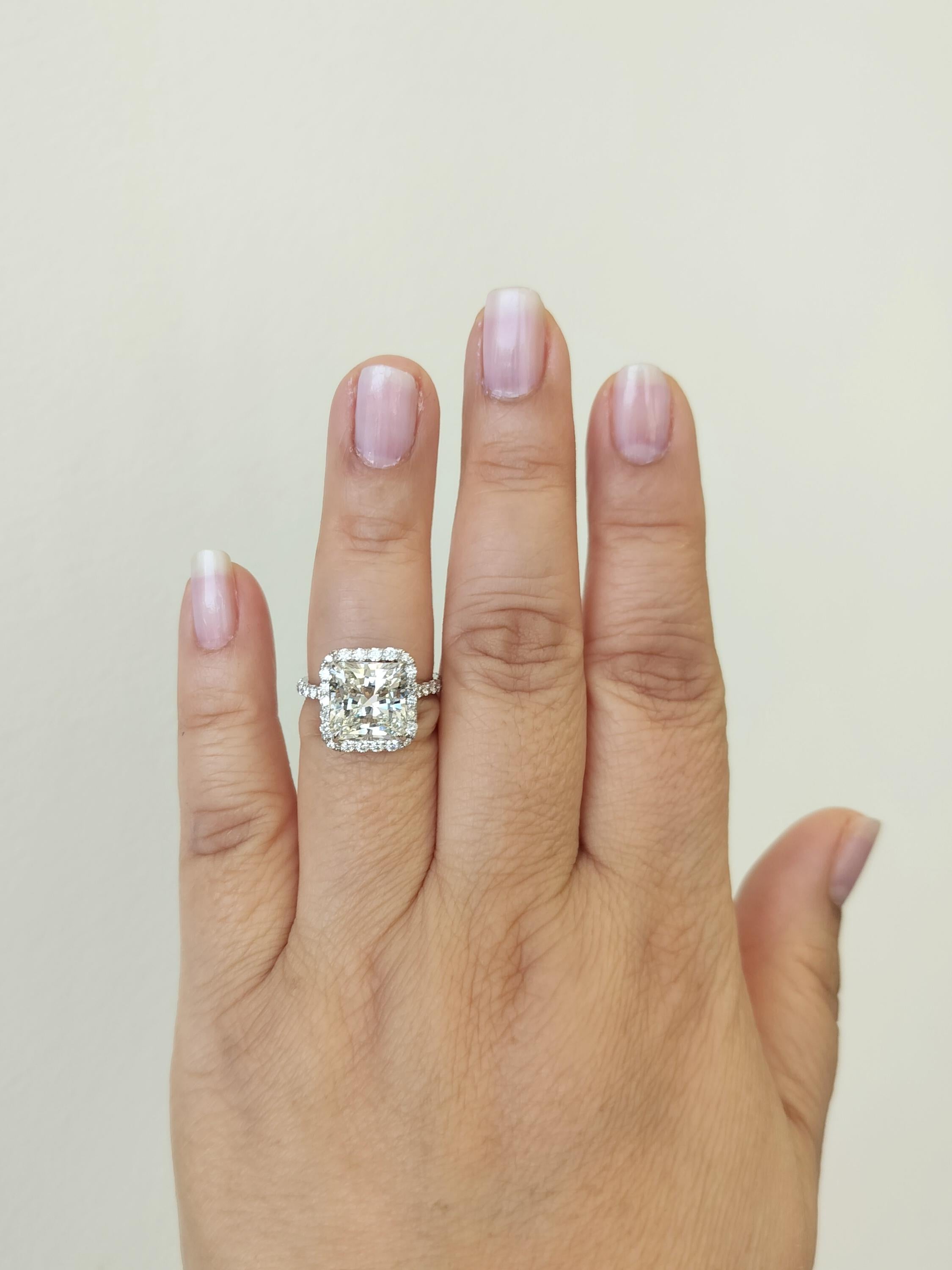 Stunning 5.27 ct. GIA I VS2 white diamond radiant cut with good quality smaller white diamond rounds.  Handmade in 18k white gold.  Ring size 7.  GIA certificate is included.