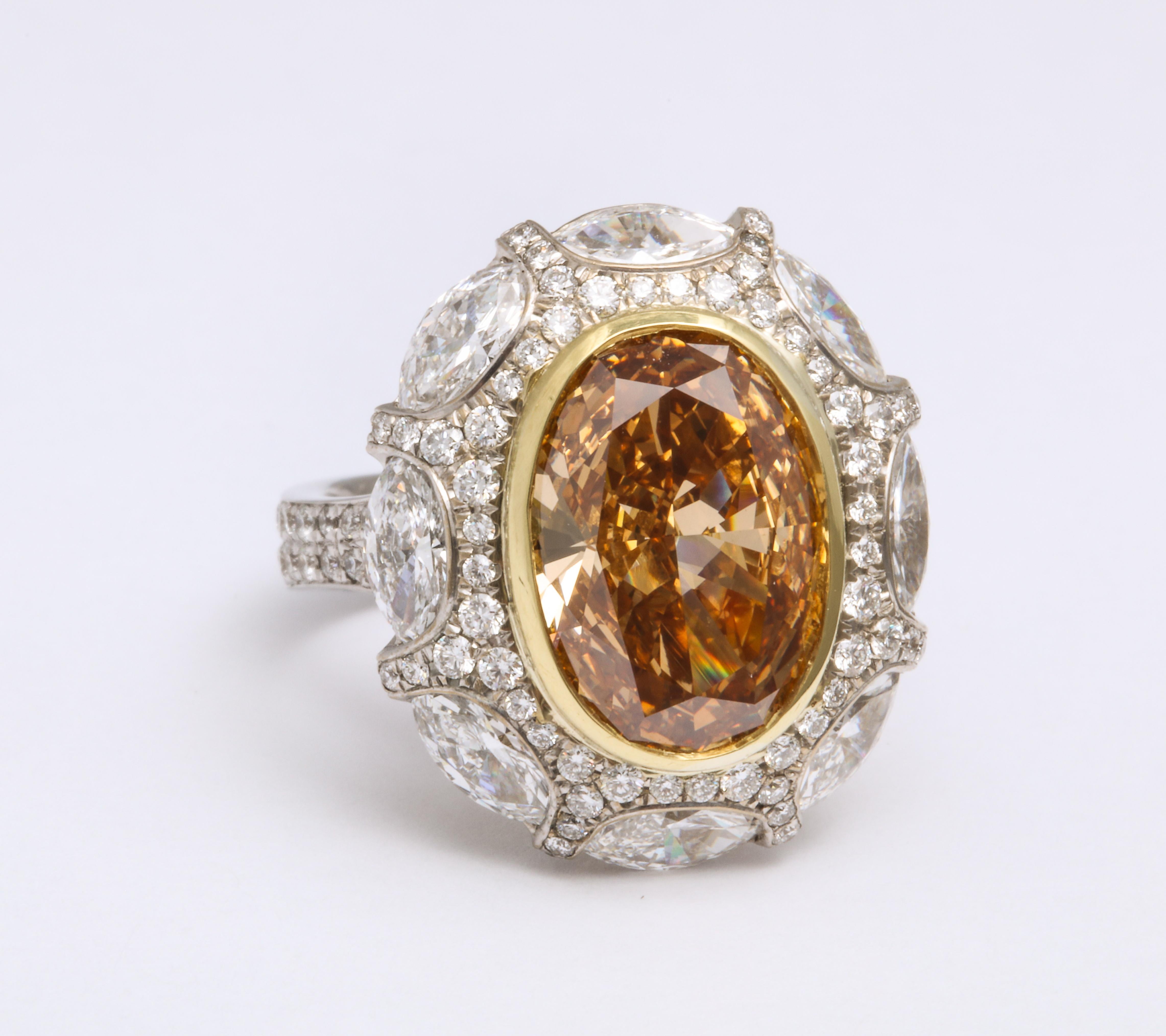 A unique and truly interesting orange diamond, this 5.34 carat oval gem comes with a GIA report describing it as a natural color diamond; Fancy Deep Brownish Yellow Orange.  The GIA report also describes this oval diamond as being a VVS2 clarity,
