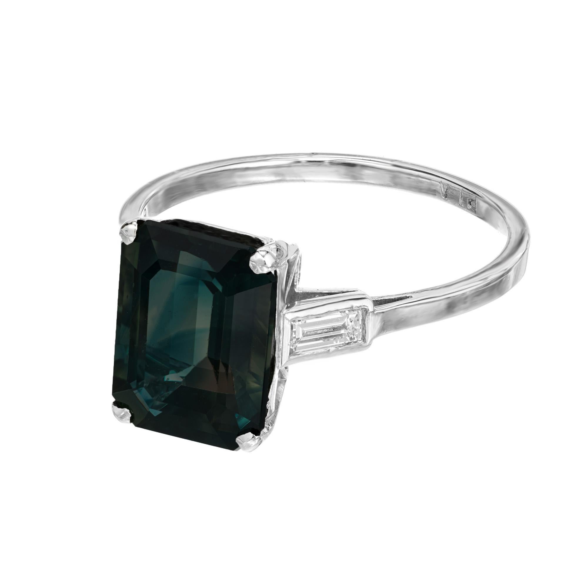 1940's Art Deco green sapphire and diamond engagement ring. GIA certified octagon shape 5.37ct rich green sapphire mounted in platinum three-stone setting with 2 straight baguette accent diamonds. This beautiful sapphire is graded by the GIA as