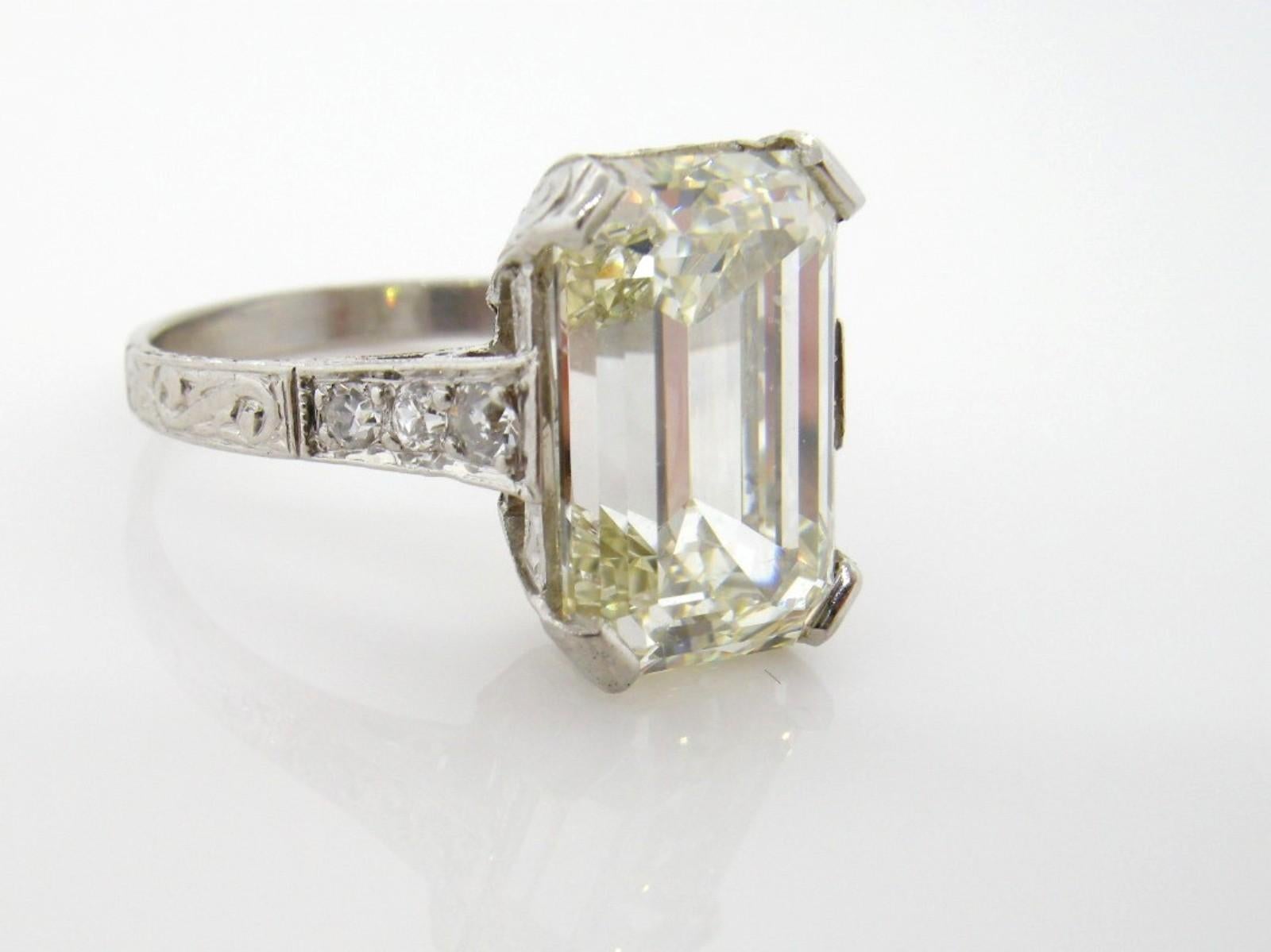 Dazzling! A beautiful recreation of an Art Deco style platinum ring, featuring a fabulous 5.38 carat Emerald cut Diamond.  The diamond is accompanied by G.I.A. Report #2205762505 stating the diamond is M color - VS2 clarity.  The 1920s style