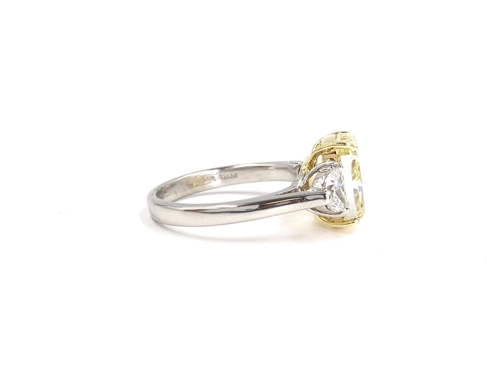 Contemporary GIA 5.55 Carat Fancy Light Yellow Cushion Diamond Three-Stone Platinum Ring