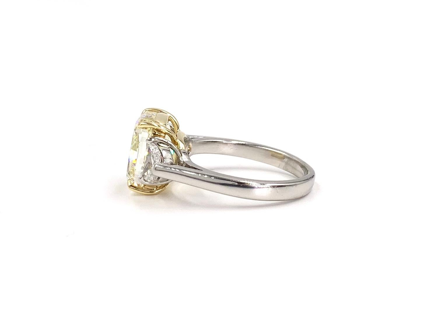 GIA 5.55 Carat Fancy Light Yellow Cushion Diamond Three-Stone Platinum Ring In Good Condition In Pikesville, MD