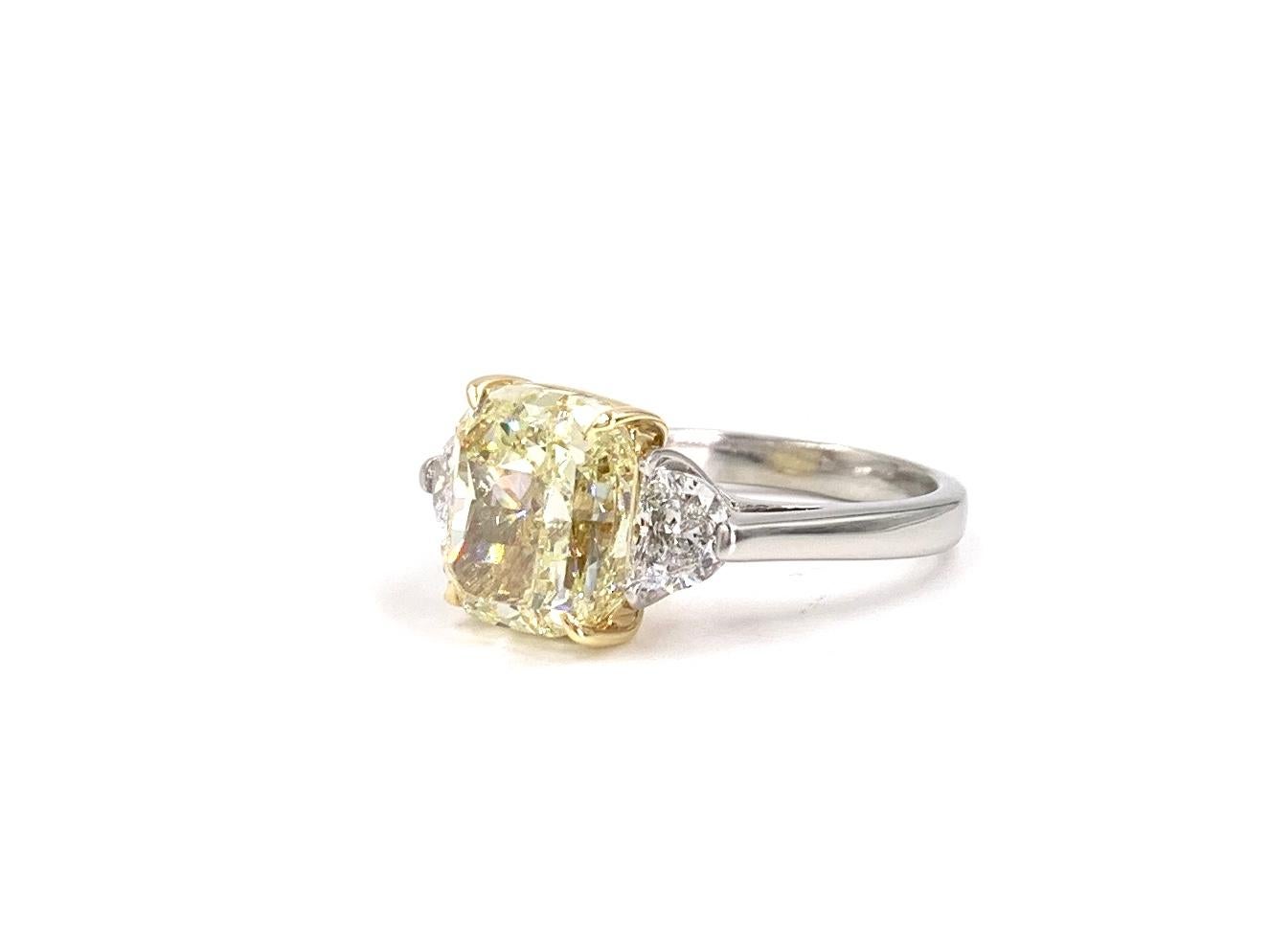 Women's GIA 5.55 Carat Fancy Light Yellow Cushion Diamond Three-Stone Platinum Ring