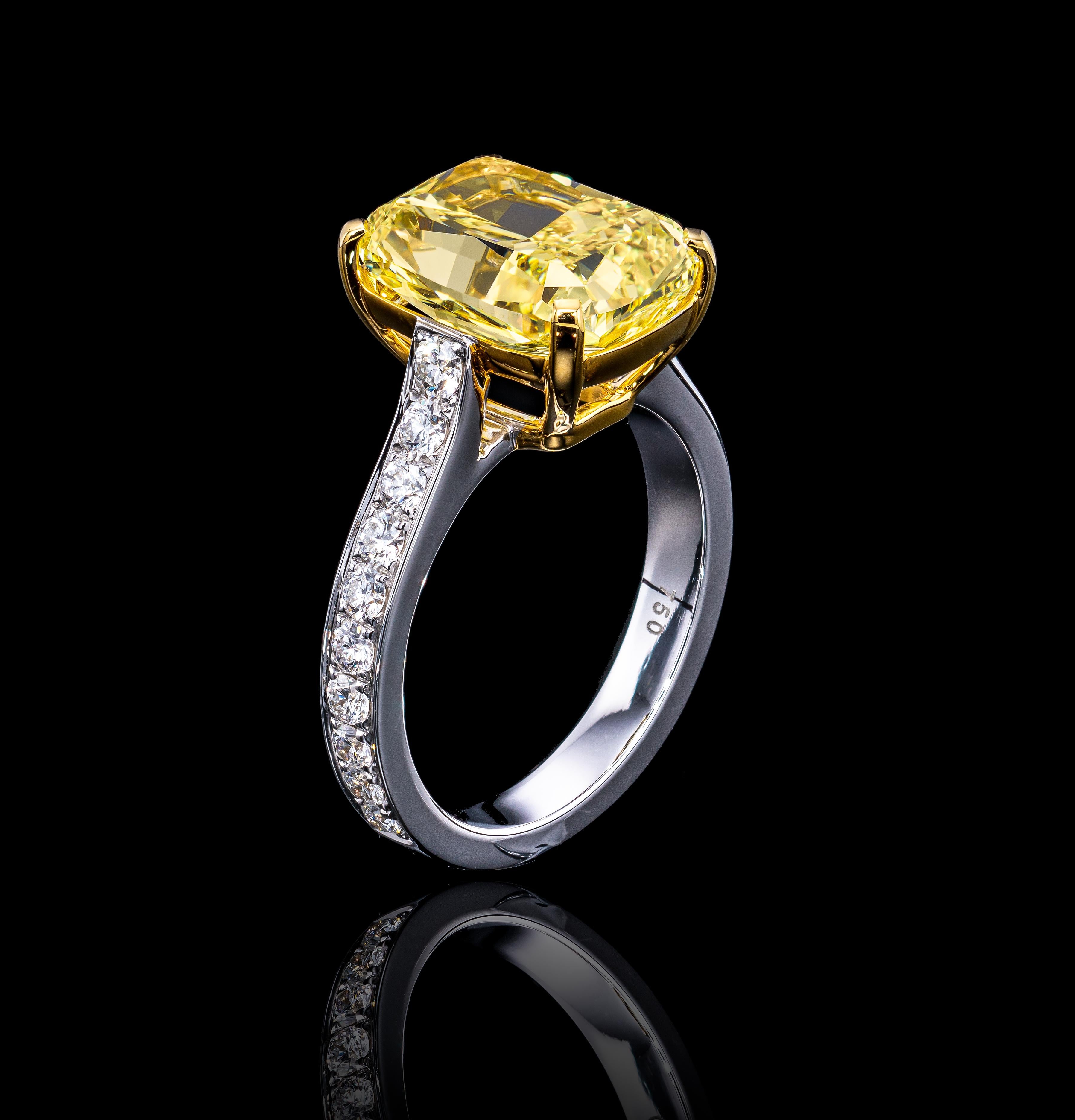 Hand Crafted 6.30 TCW Fancy Intense Yellow diamond ring that is designed to endure glamour anywhere you go. 
The timeless ring features a stunning Cushion cut 5.73 Carat GIA certified Natural Fancy Yellow diamond VS1 clarity. The diamond is accented