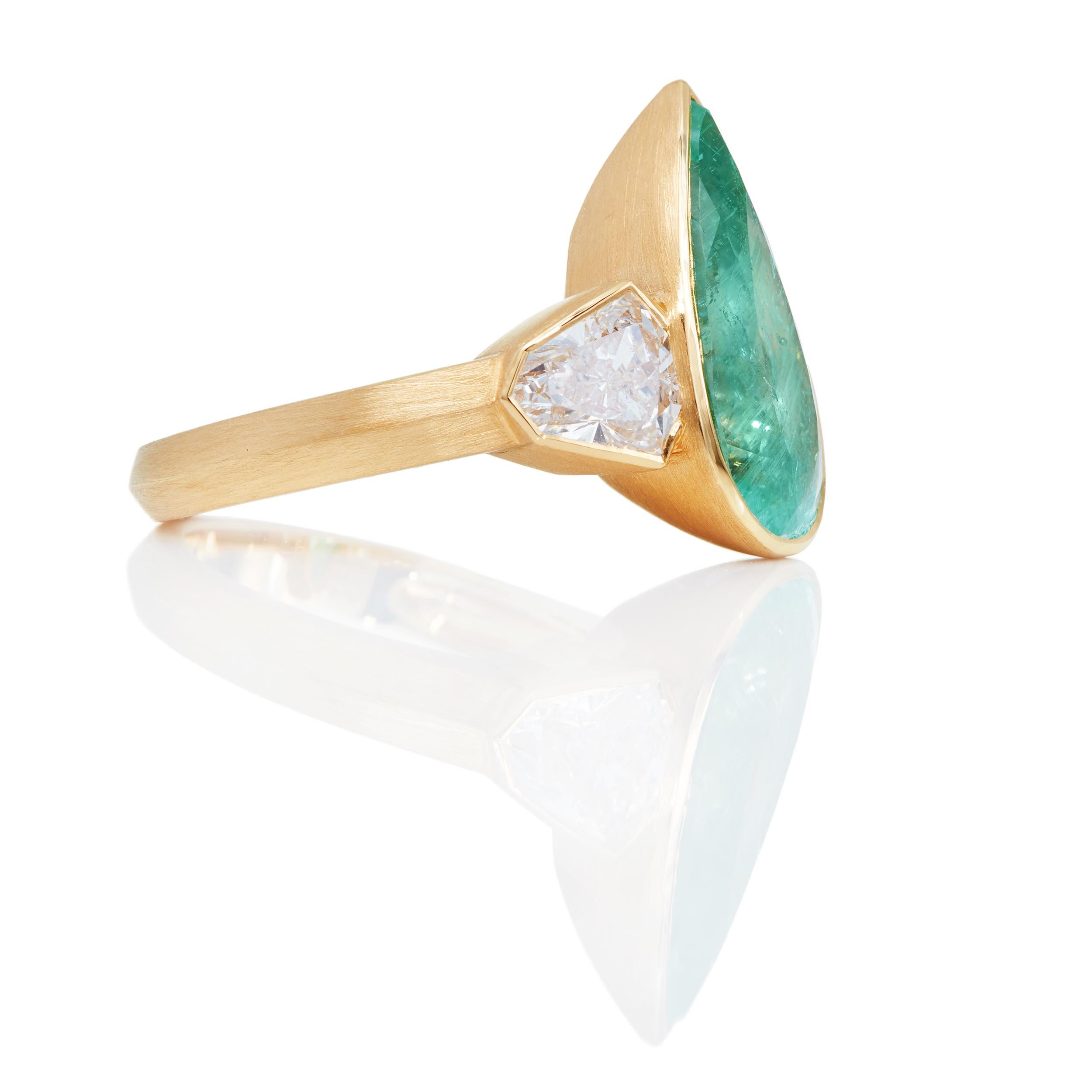 Gorgeous ring in 21 Karat yellow gold brushed finished. 

5.78 Carat Paraiba-type Tourmaline - origin Mozambique 

Diamond Detail:

(2) Shield-shaped Diamonds weighing 1.27 Carats
D Color
SI1 Clarity

Ring size 5.0
*Sizable upon request