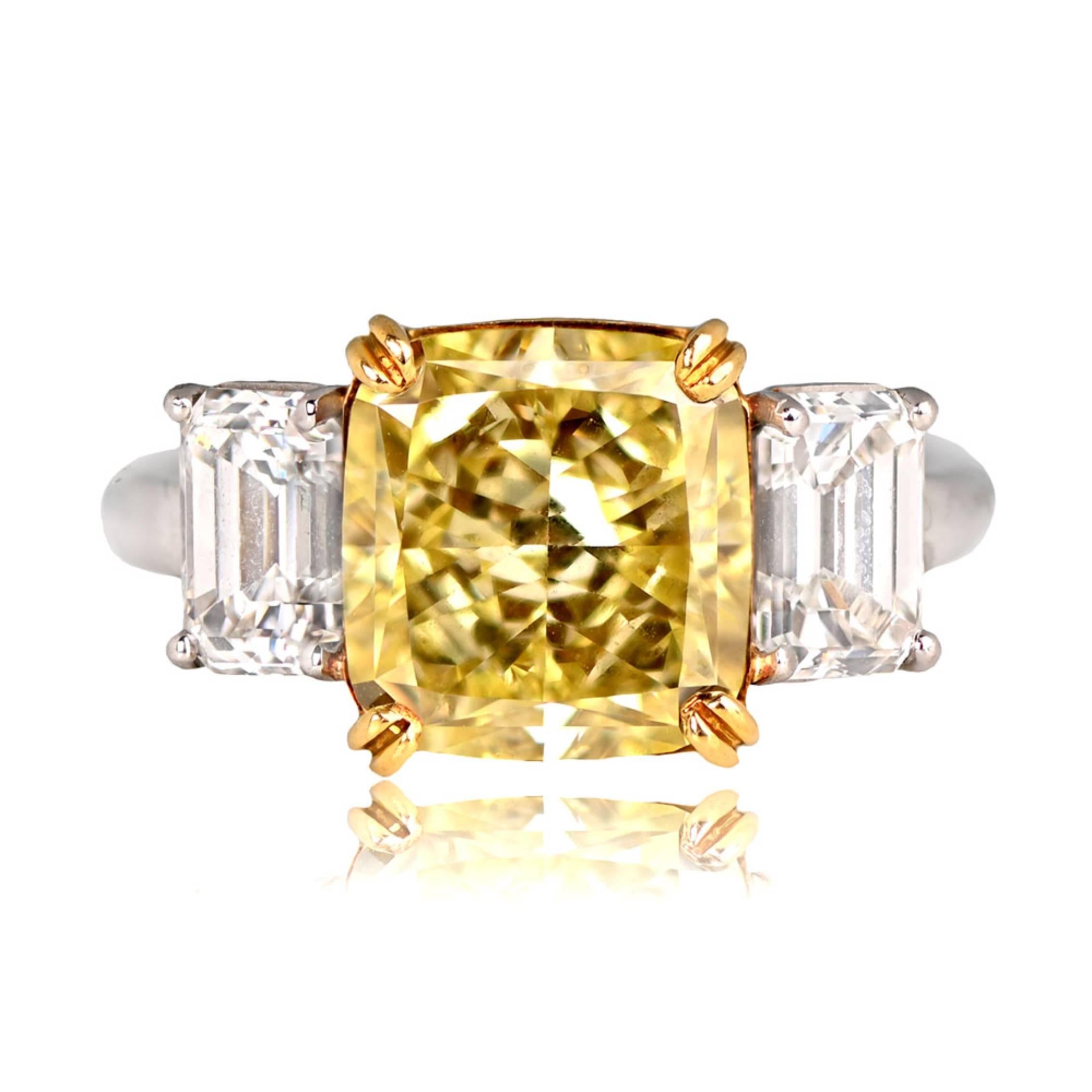 A striking three-stone diamond ring with a 5.78-carat natural Fancy Yellow radiant cut diamond, VS2 clarity. Flanking the center stone are two emerald-cut diamonds, approximately 0.75 carats each. The center diamond is prong-set in yellow gold,