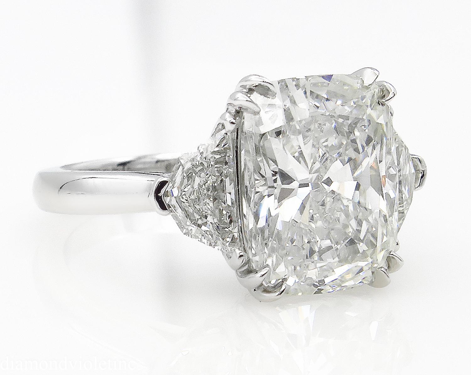 A Breathtaking Estate HANDMADE PLATINUM (stamped) Cushion Diamond Three-Stone Engagement ring. The Prong Set Radiant Diamond is 5.02CT with measurements of 11.58x9.20x6.08mm. GIA Certified as K color and I1 clarity (Eye Clean).
It is set with 2