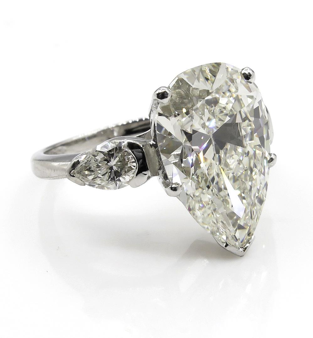 From our Estate Collection comes this Timeless Important Large Vintage Platinum (stamped) Engagement Ring with GIA Certified Pear Shaped Center Diamond in Shy 5.5 carats (5.42ct) K color VVS2 clarity - SUPER CLEAR, near FLAWLESS, warm WHITE and