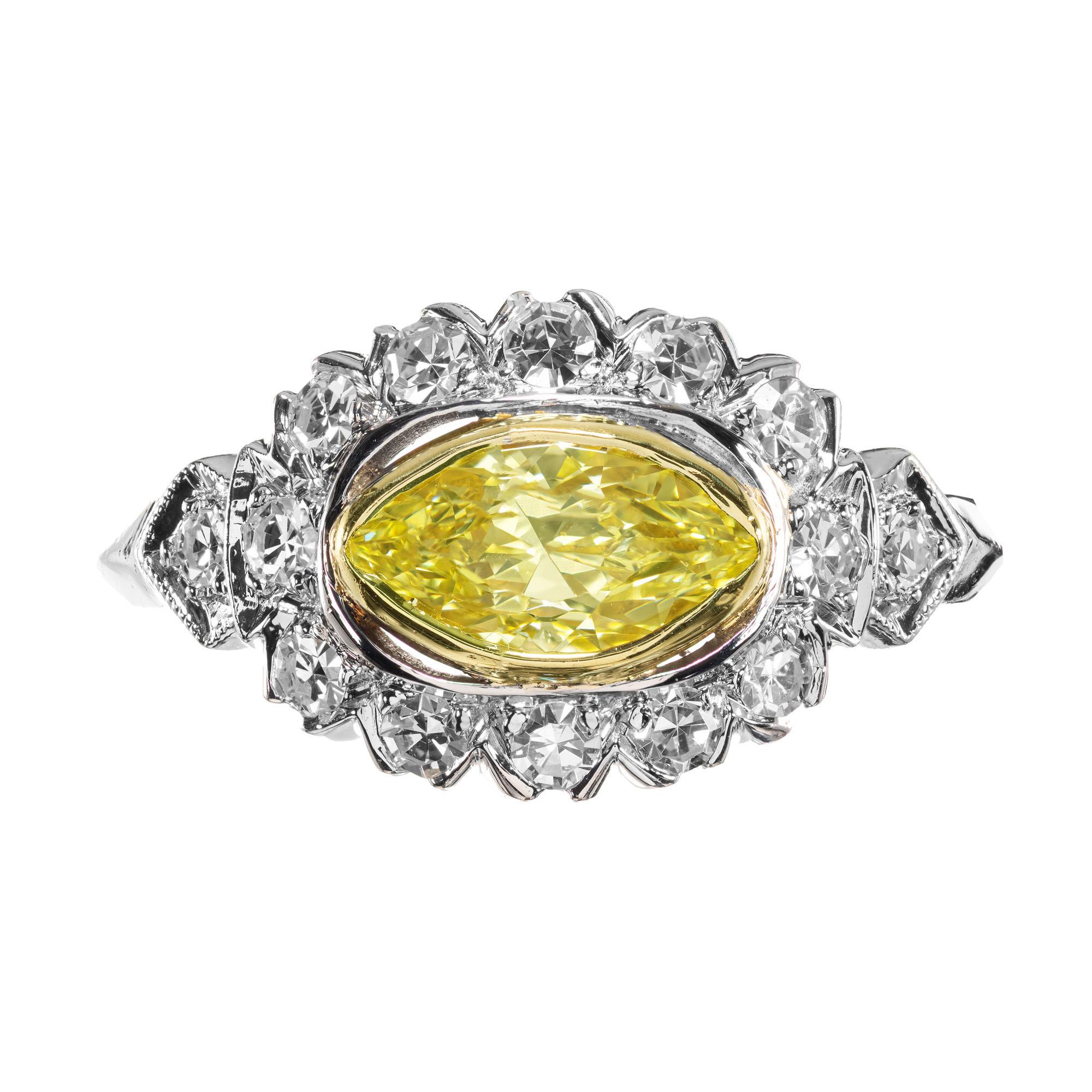 Breathtaking fancy intense natural yellow GIA certified .65 carat diamond Marquise shape in its all original Platinum 1940’s engagement ring setting. Accented with a halo of 14 single cut diamonds. Sits across the finger and has a distinctive unique