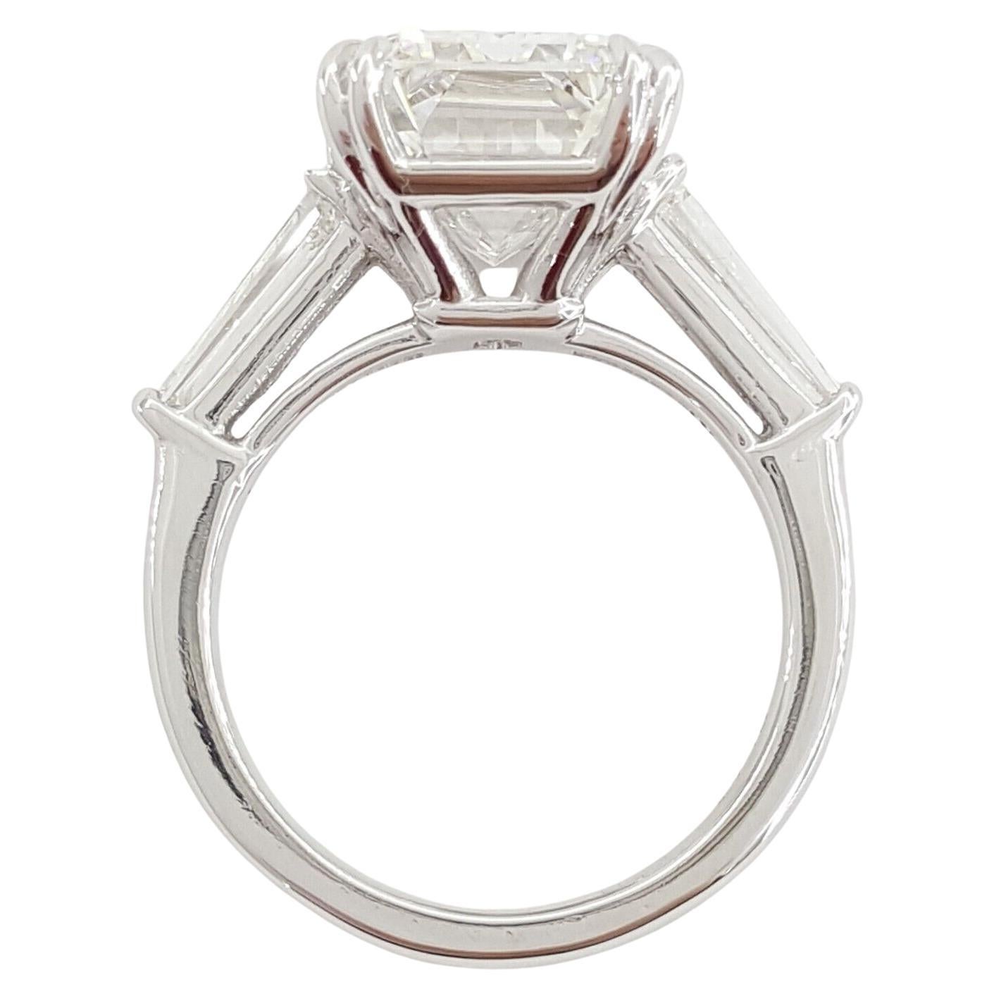 7.03 ct total weight Platinum Emerald Cut Diamond Three-Stone Engagement Ring.



The ring weighs 9.5 grams, size 5.5, the center stone is a Natural Emerald Cut diamond weighing 6.38 ct, E in color, VVS2 in clarity, 62.4% Depth, 67% Table, Ideal