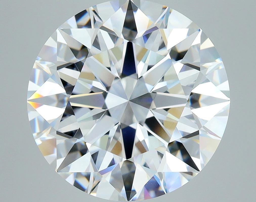 Elegantly designed, this stunning diamond ring captivates with its remarkable features. At the heart of this piece lies a breathtaking round F VS1 7.05 diamond, securely held in a raised prong setting that enhances its brilliance and fire. The band,