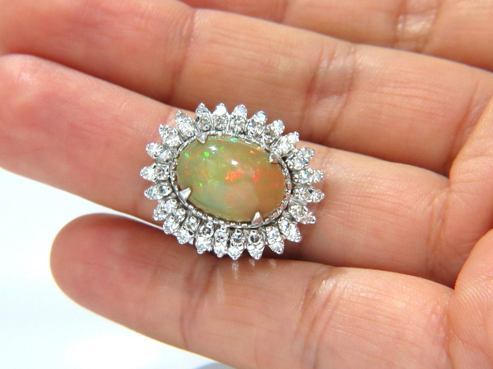 Play of color.

GIA Certified 

5.97ct. Natural Non treated Opal ring.

Report: 2145457599

Oval cut: 14.80 X 10.90  X 7.90mm

threads of greens, orange and some yellows.

Phenomenon: 