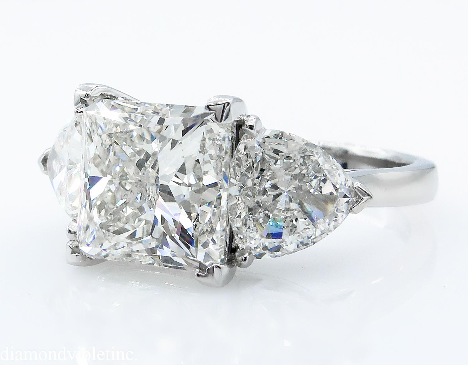 A Breathtaking Estate HANDMADE PLATINUM (stamped) Princess cut Diamond Three-Stone Engagement ring. The Square Prong Set Princess Diamond is 4.52CT with measurements of 8.86x8.64x6.48mm; GIA Certified as L color and SI1 clarity (Appears Warm White