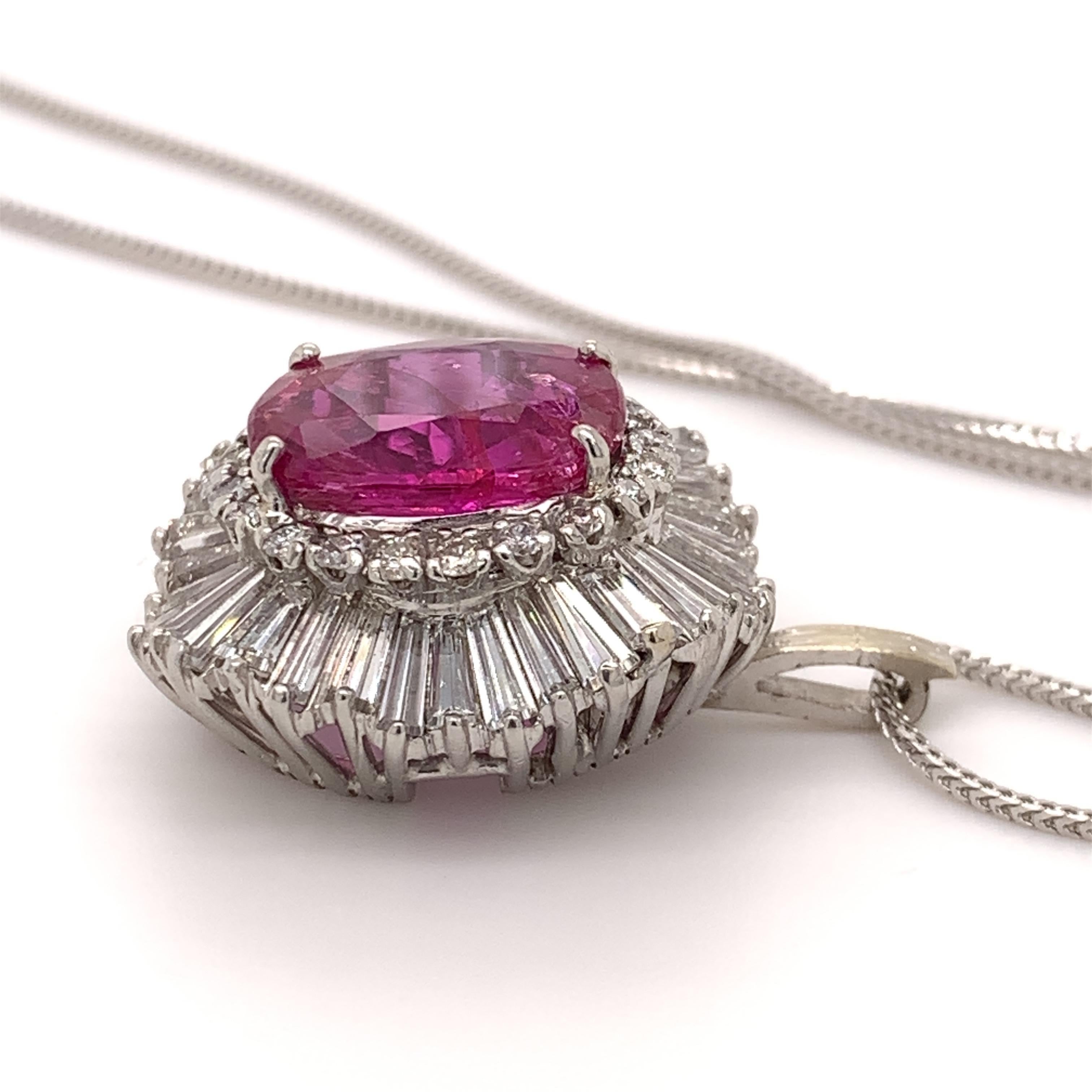 Collectible unheated ruby pendant. Lively pinkish-red tone, high brilliance, oval faceted unheated 7.47 carats ruby mounted in high profile with four bead prongs, accented with a tapered baguette diamond and round brilliant cut diamonds. Handcrafted