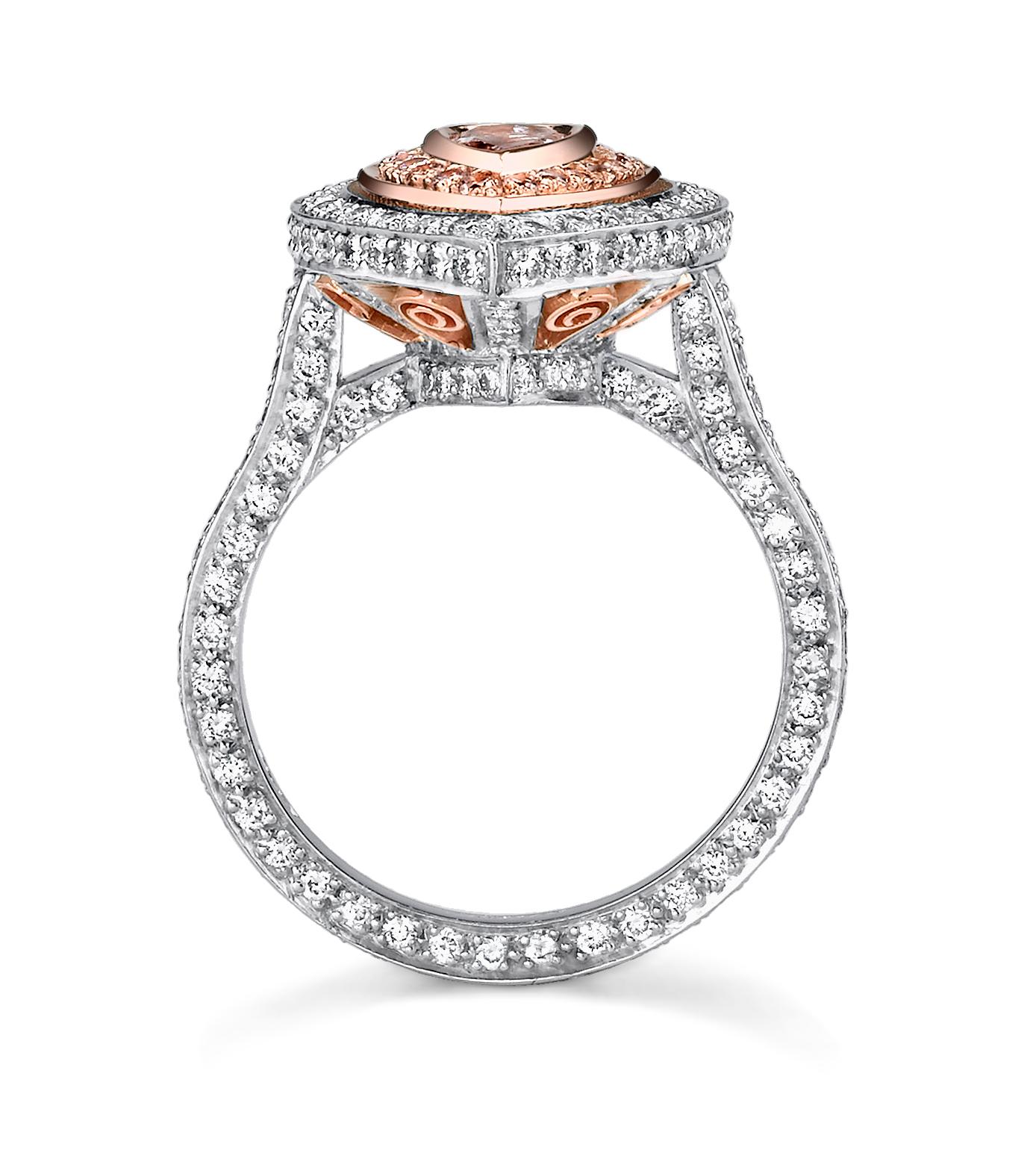  This flirty, feminine ring features a 0.75 ct pear-shaped natural fancy pink diamond set in delicate  18 Rose Gold and Platinum accented with filigree detail. This striking center stone is framed in 0.19 ct natural pink diamonds and 1.70 ct white