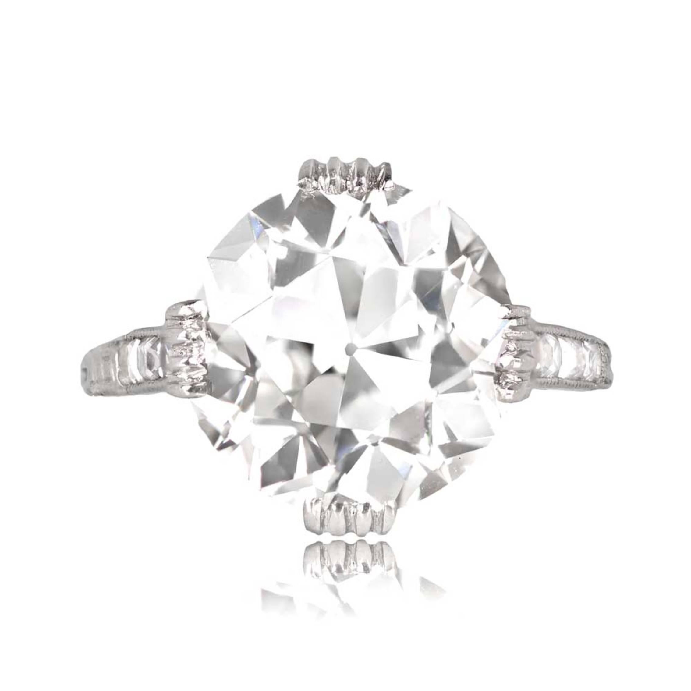 A platinum solitaire ring with a 7.55-carat GIA-certified old European diamond (K color, VVS2 clarity) in a prong setting. The ring also boasts antique French cut diamonds on the shoulders, and the mounting is adorned with intricate open-work, hand