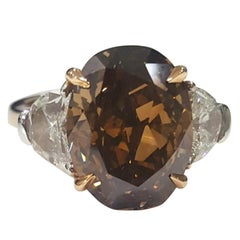 Used GIA 7.97 Carat Natural Fancy Dark Orange Brown Oval brilliant Diamond Ring.