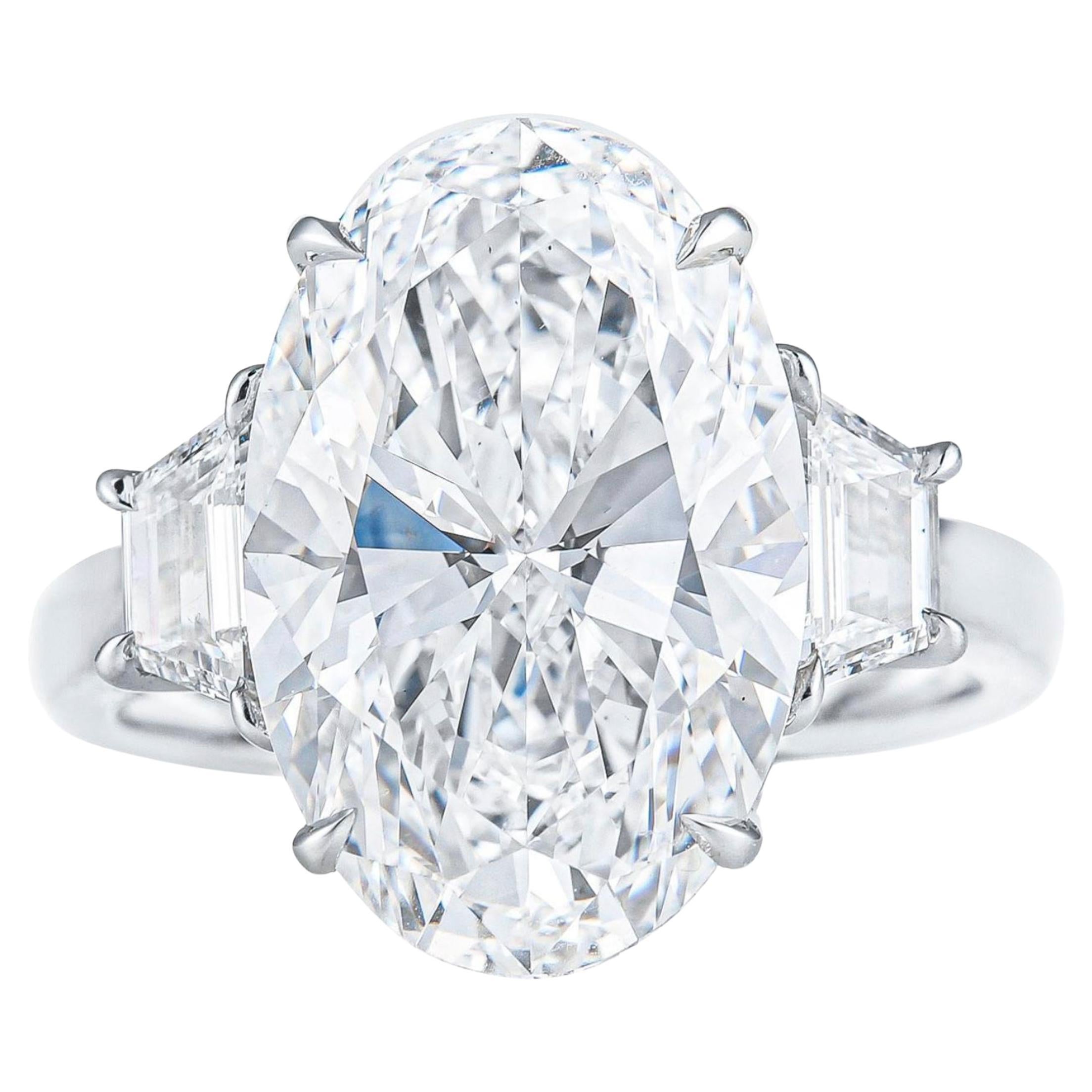 GIA 8 Carat D VS2 Oval Diamond Platinum Ring with Step-Cut Trapezoids For Sale