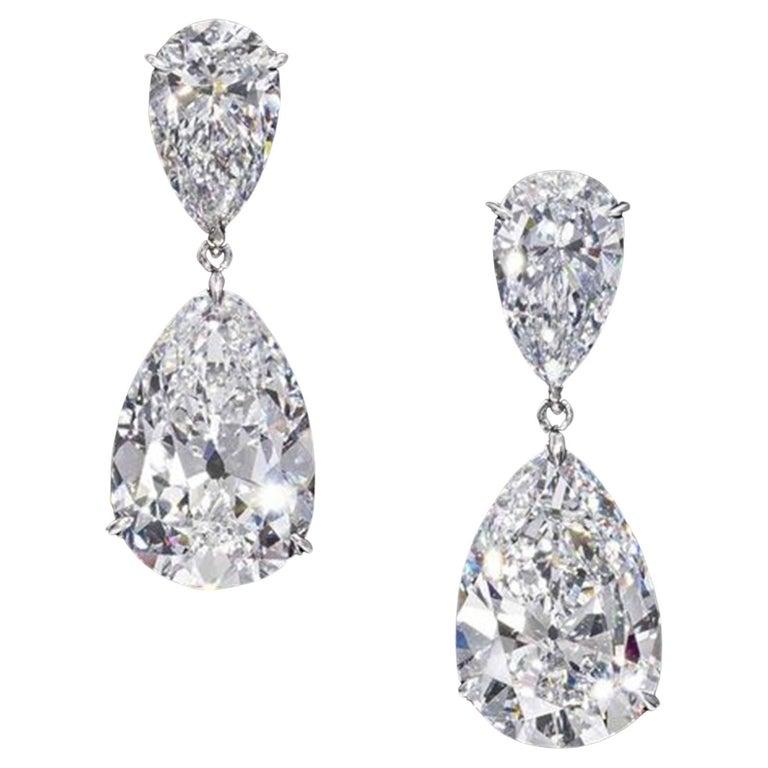 Elevate your ensemble with the exquisite elegance of this GIA 8.03 Carat Matched Pair of Pear Cut Diamonds set in 18K White Gold earrings. Each earring features a stunning pear-cut diamond of exceptional quality, certified by the prestigious