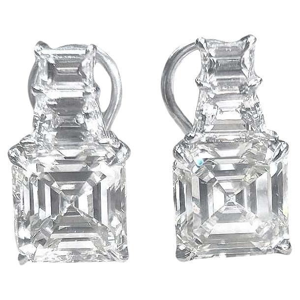 Exquisite Asscher Cut Diamond Earrings
Indulge in the opulence of these stunning diamond earrings, featuring a breathtaking 8.04ct pair of Asscher cut diamonds. Paired with trapezoid and baguette cut accents, these earrings offer a graduated look