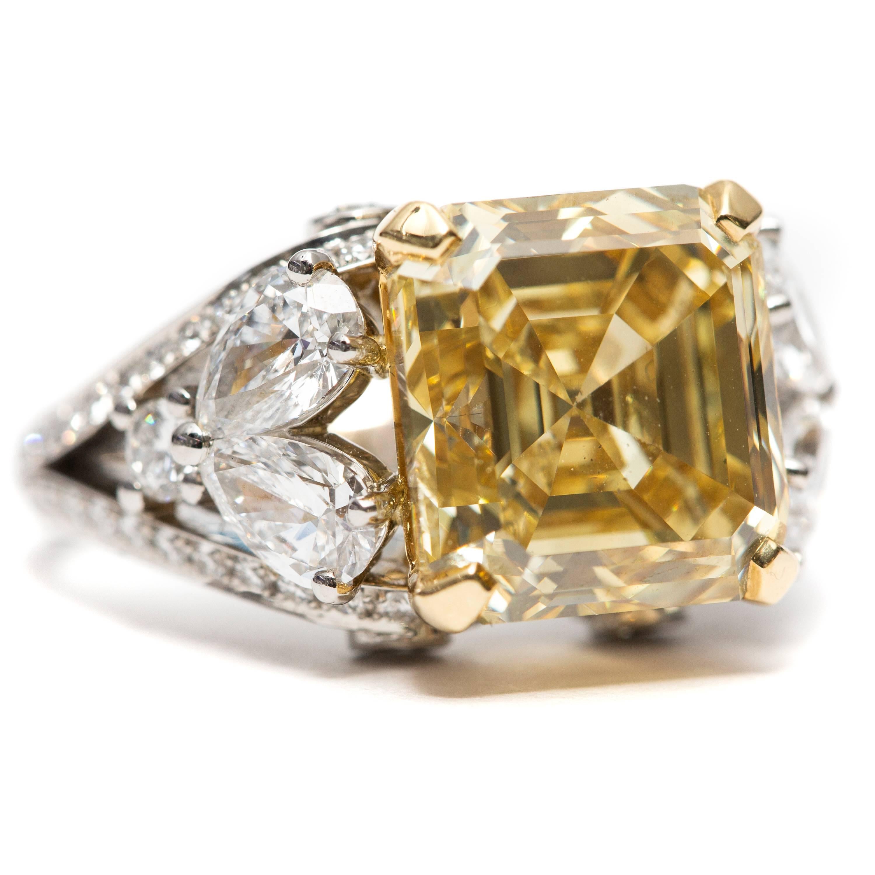 This Astonishing GIA Certified 8.15 Carats Fancy Brownish Yellow Diamond Emerald Ring for that glamorous look. This exceptional Fancy design features 0.19 Carats Pear Shaped Diamonds and 1.06 Round Brilliant Color H Clarity SI1 Diamonds set in