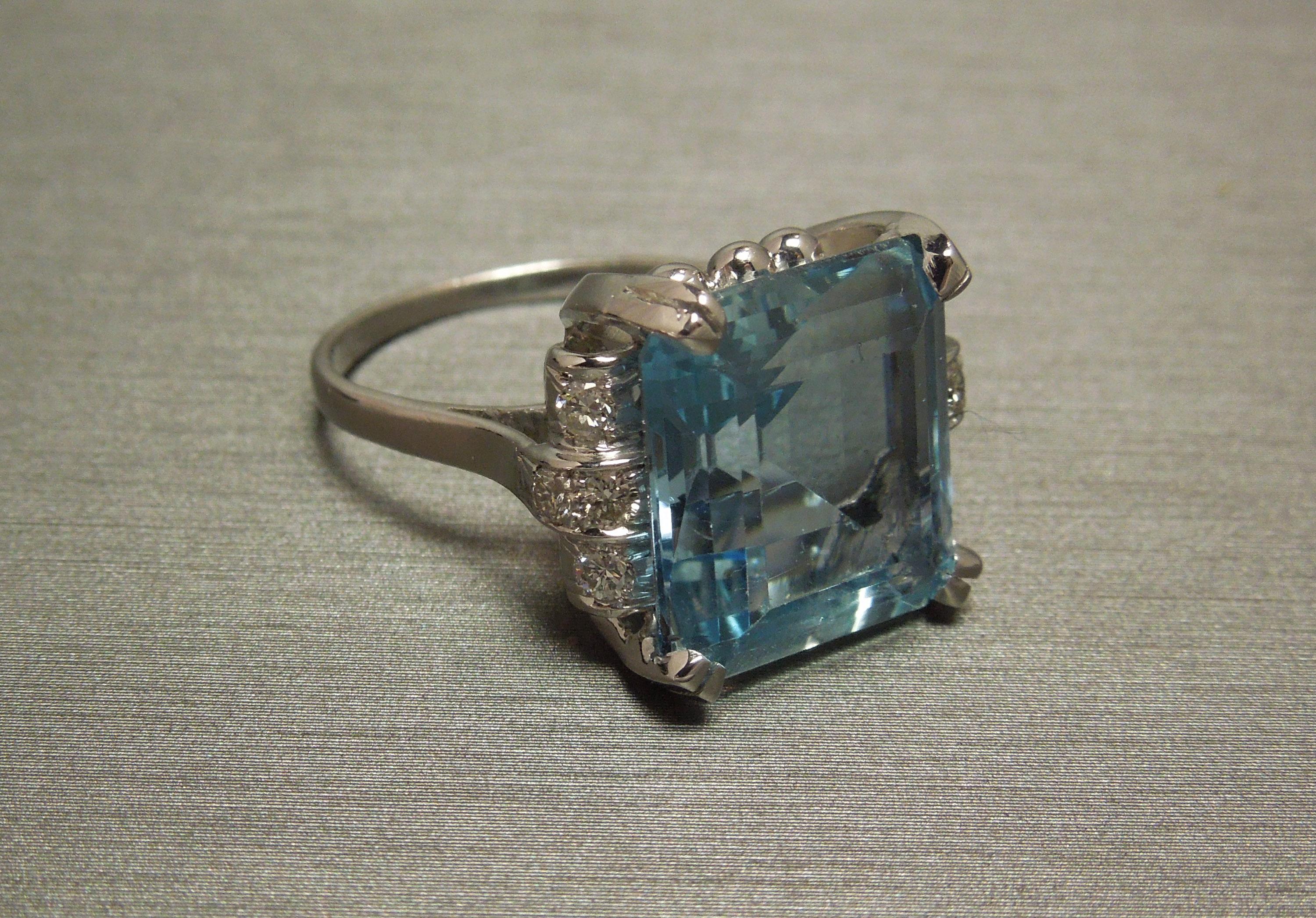 Constructed completely of Platinum, with 1 Focal G.I.A. Certified Octagonal Square cut Natural Intense Blue 9.50 carat Aquamarine, at 14mm in length x 13mm in width, securely set in four Platinum prongs. With a total of 8 Colorless Nearly Flawless