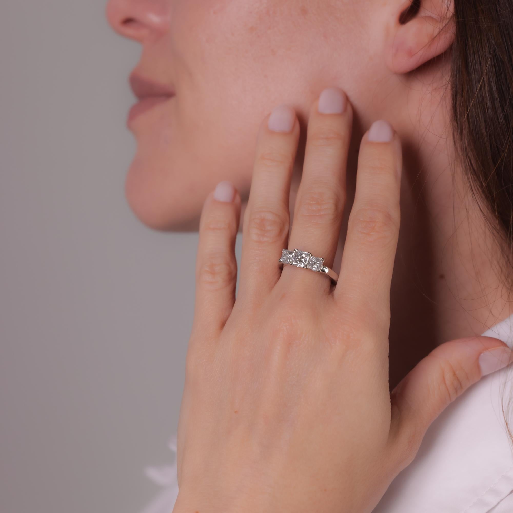 This modern platinum ring features a GIA-certified 0.96-carat princess-cut diamond, F color, VS2 clarity, accented by two princess-cut diamonds totaling approximately 1 carat, F color, VS clarity. Circa 2020s.


Certificate: GIA #6331434622
Center