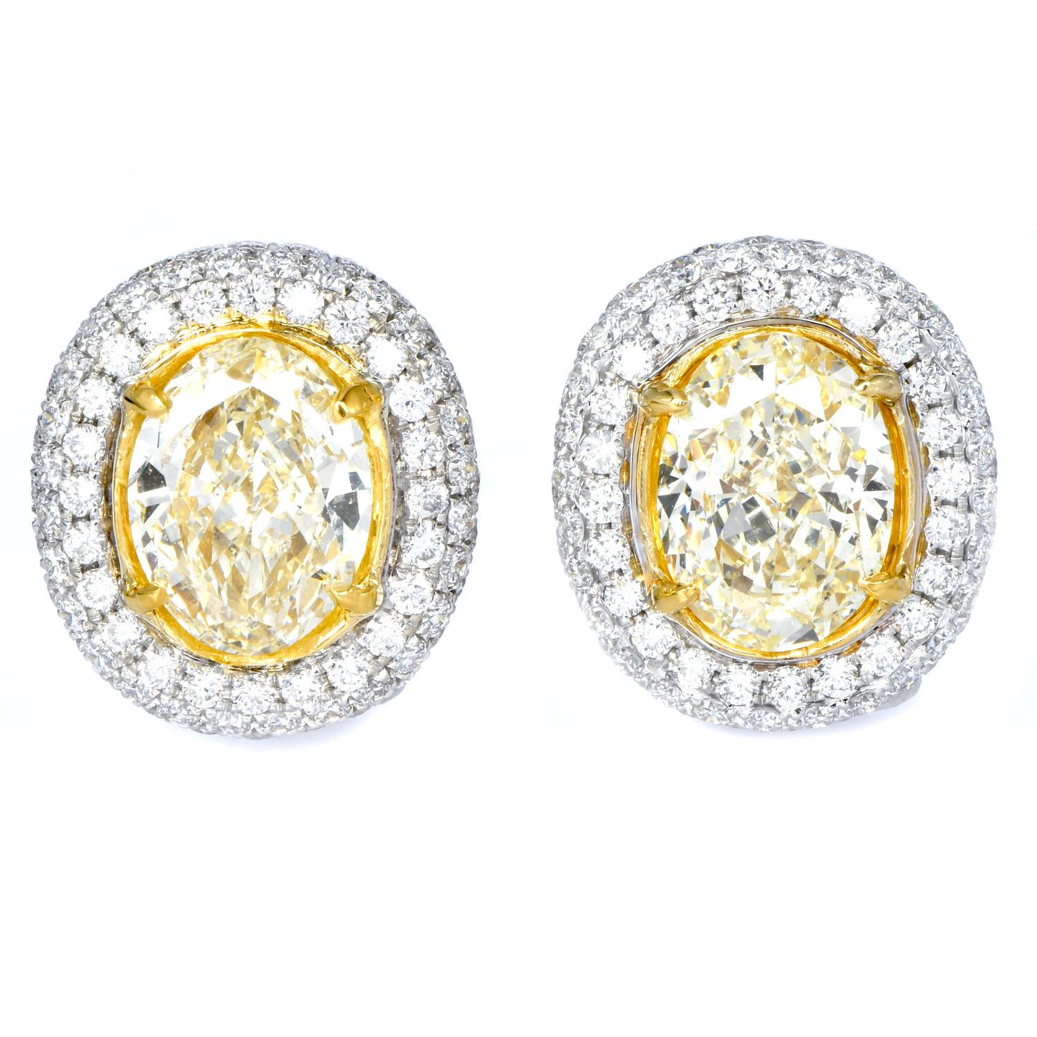 You’ll feel glamorous and like royalty with these natural Yellow oval shape Diamond  Halo Stud Earrings.  The two Center Oval natural yellow diamonds weigh 3.10 carats U to V range VS1 clarity and 3.59 U-V color SI1 clarity bedded in a yellow gold