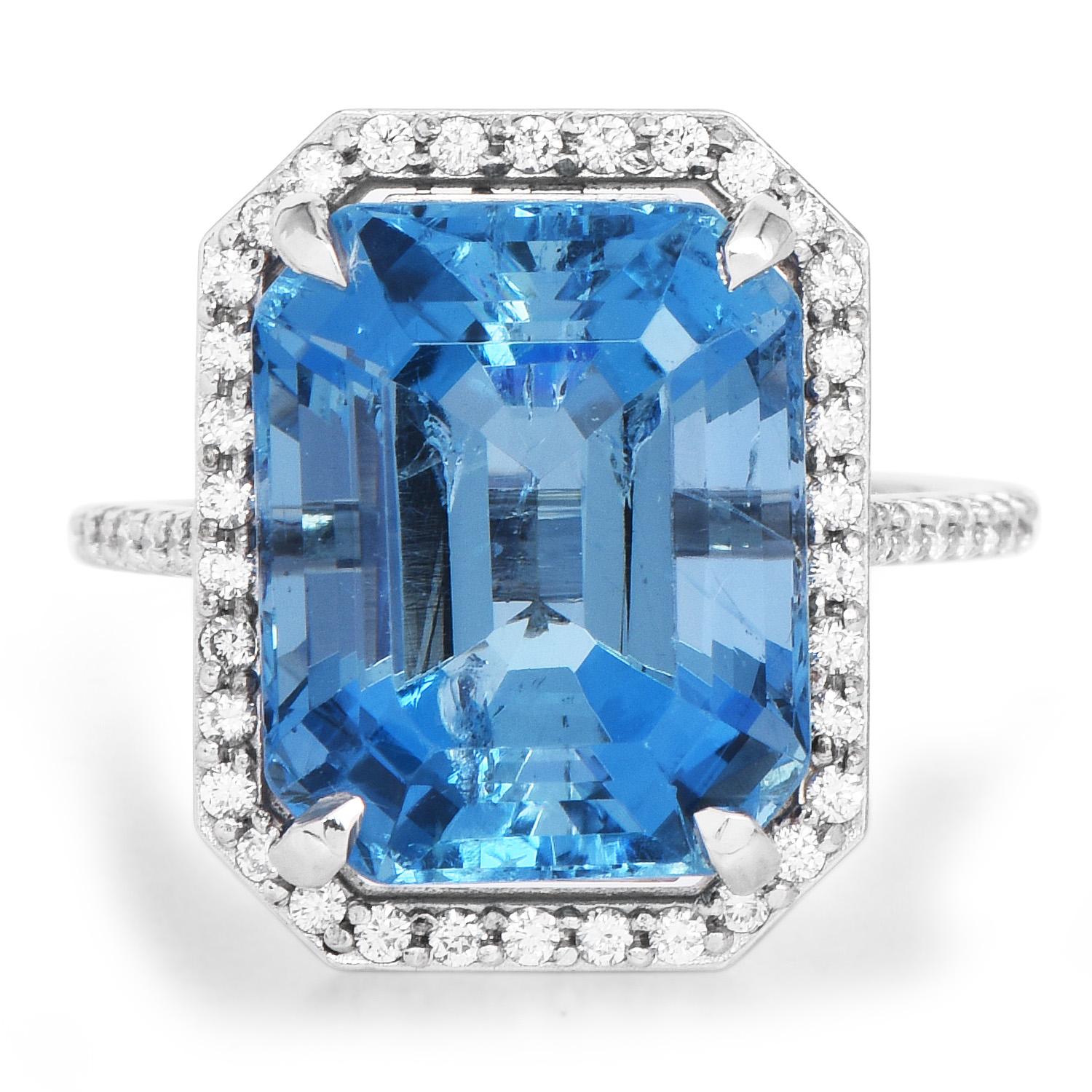 This exquisite cocktail ring has a halo style design,

and it is crafted in solid Platinum.

Prominently featured in the center is a GIA certified 9.83 carats, octagonal step cut, extremely High-Quality deep blue genuine Aquamarine, 

Surrounded by