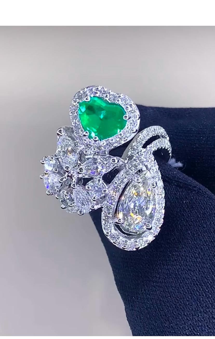 Joyful moments! This exquisite designer ring is the epitome of luxury. Featuring dazzling emerald and a multitude of scintillating white diamonds, it exudes opulence and refinement.
A true statement piece that exquisitely showcases the finest