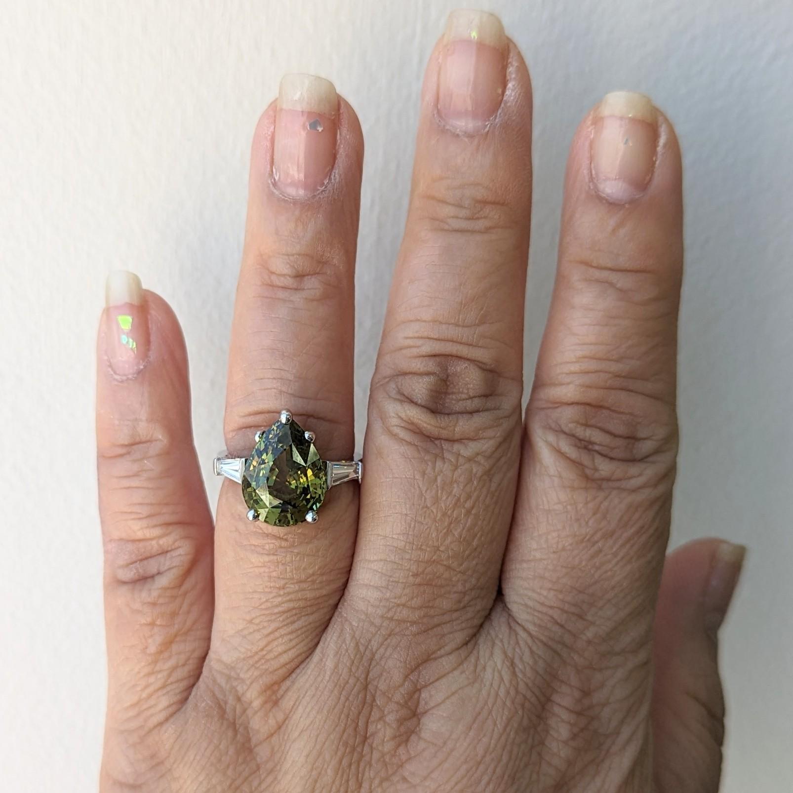 Gorgeous 8.53 ct. color change alexandrite pear shape with good quality white diamond baguettes.  Handmade in 18k white gold.  Ring size 7.  The color changes from yellow green to brownish yellow.  GIA certificate included.