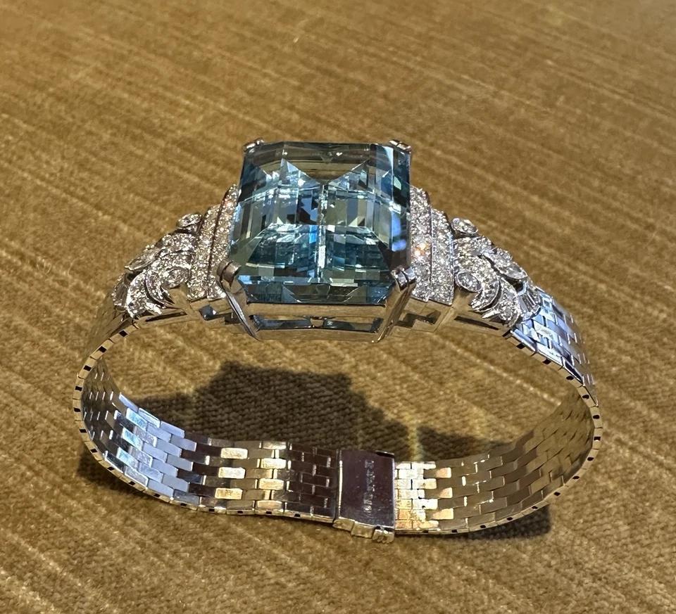 GIA Aquamarine 38.10 ct and Diamond Vintage Bracelet in Platinum and White Gold

Vintage Aquamarine Bracelet features a GIA certified Emerald cut Aquamarine weighing 38.10 carats flanked by two rows of Round Brilliant Diamonds attached to a Flat