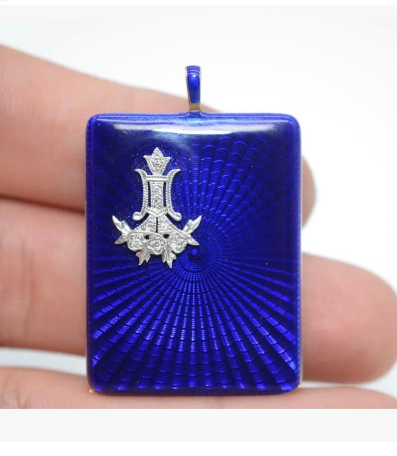 This is a magnificent Art Deco Antique Diamond Platinum Locket Pendant in Royal Blue Guilloche Enamel over 14 Karat Yellow Gold dating to 1922.  The extraordinary Art Deco Locket is adorned with Old Mine Cut Diamonds set in an elegant Platinum