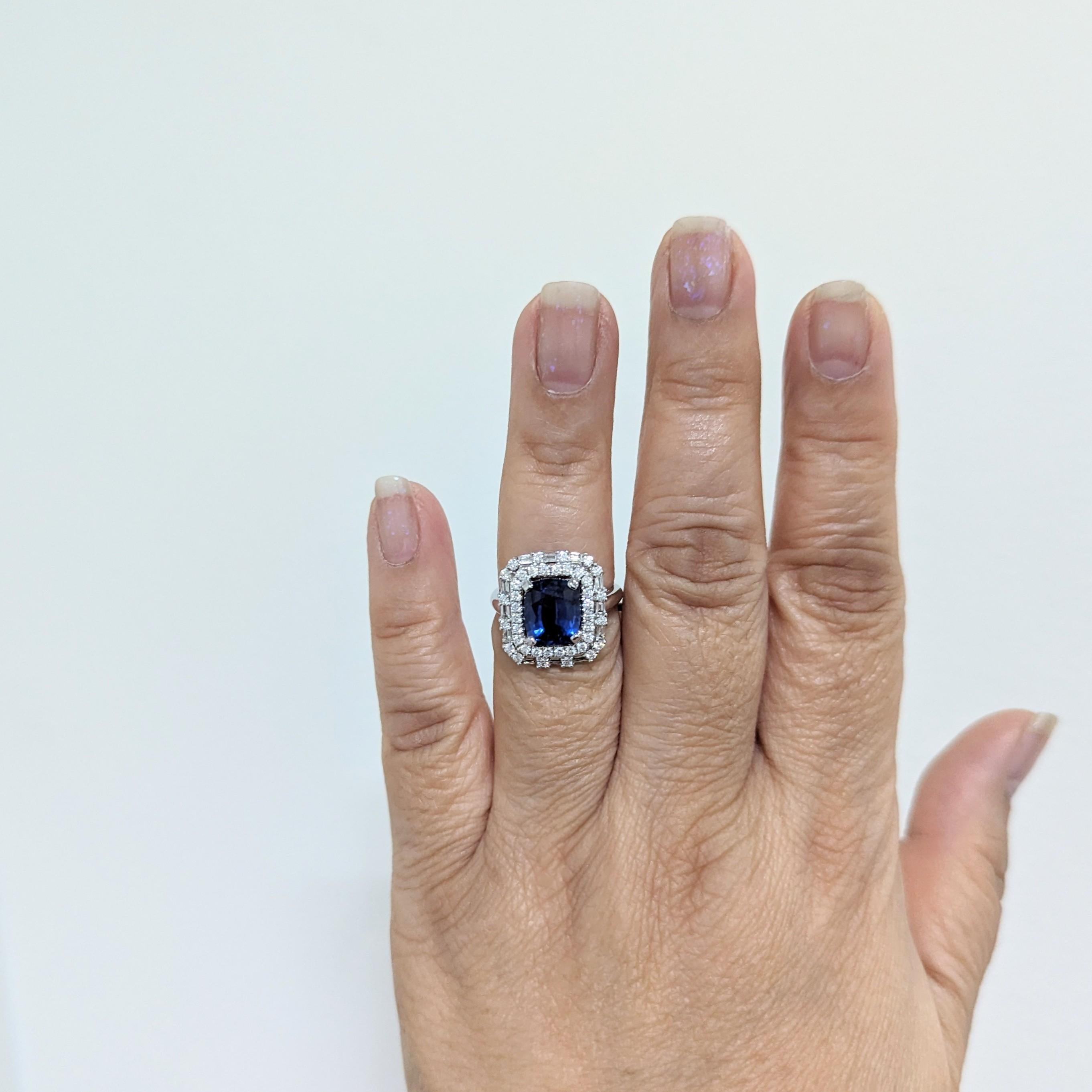 Beautiful 3.11 ct. blue sapphire cushion with good quality white diamond rounds and baguettes.  Handmade in 14k white gold.  Ring size 6.5.  GIA certificate included.