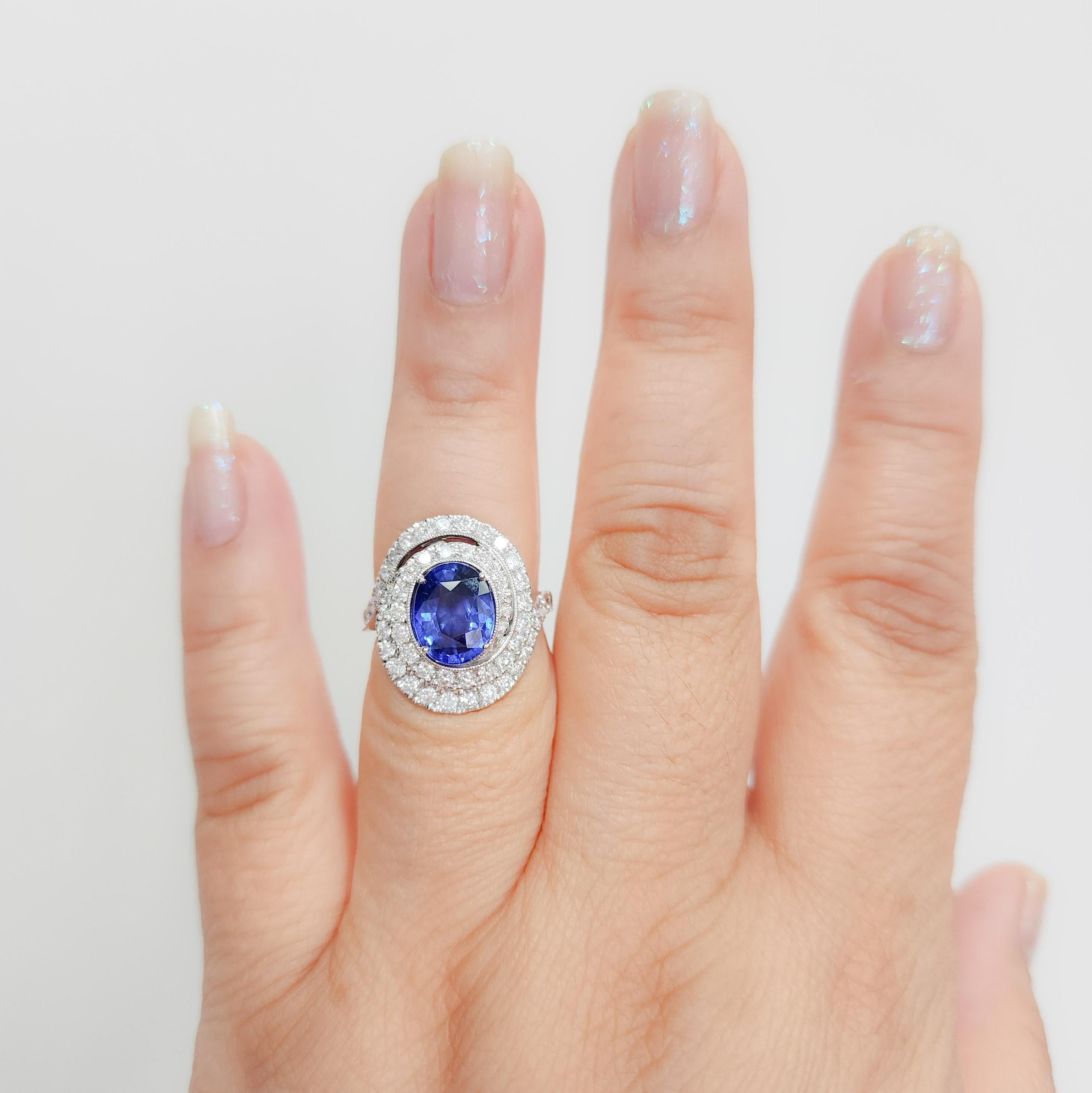 Beautiful 3.28 ct. blue sapphire oval with 1.52 ct. good quality white diamond rounds.  Handmade in 14k white gold.  Ring size 6.5.  GIA certificate included.
